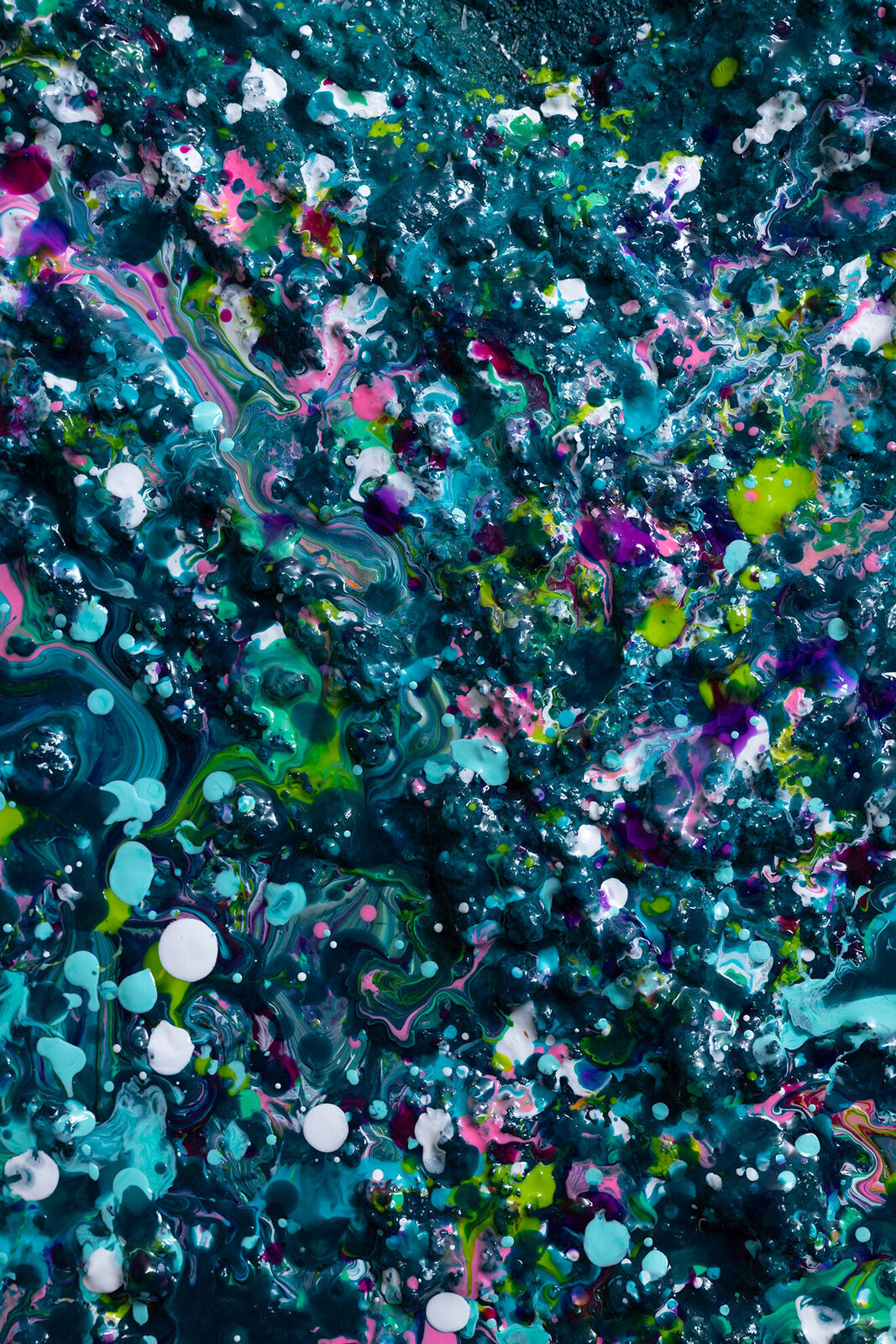 A painting of a heart made out of paint splatters on a black background.