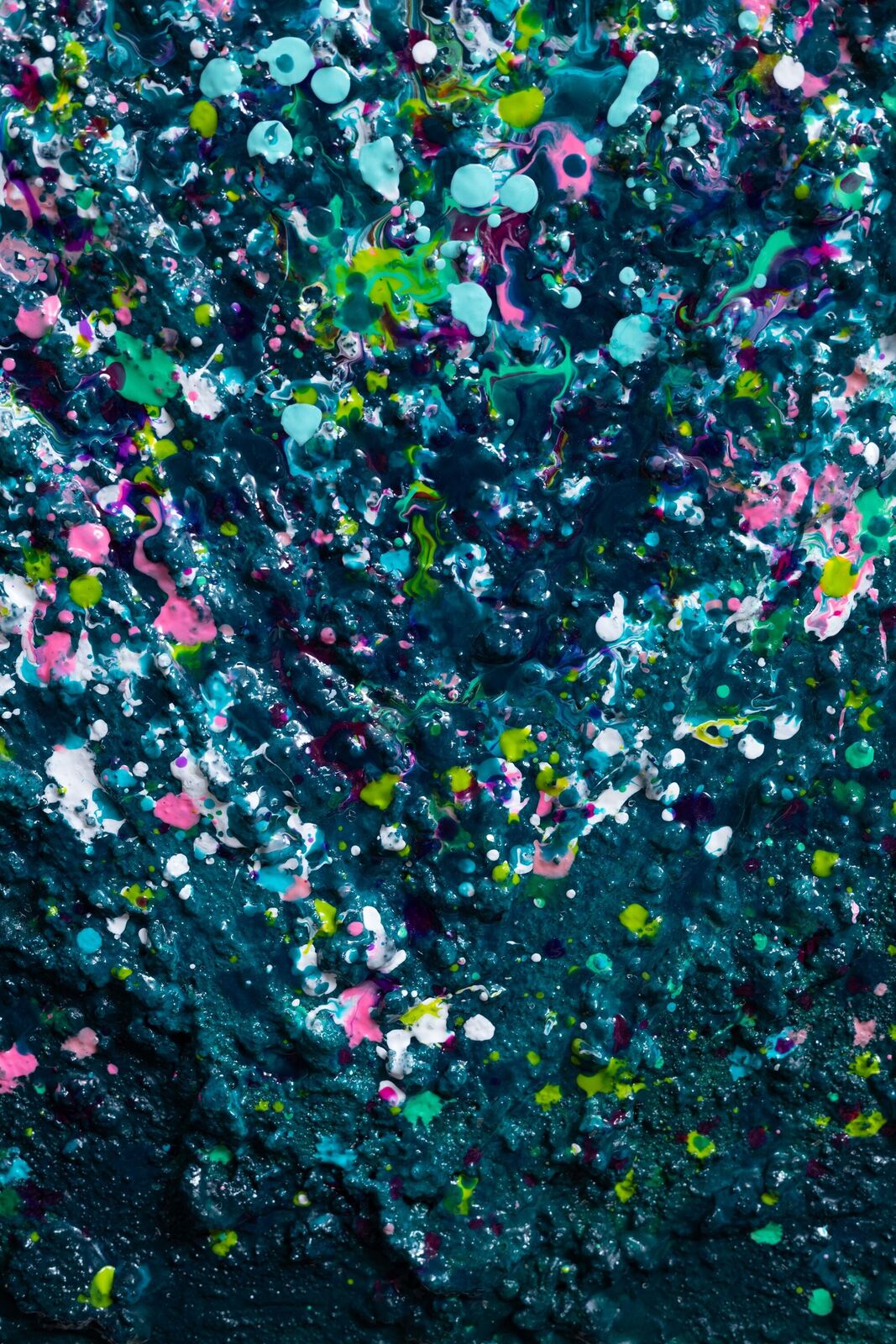 A painting of a heart made out of paint splatters on a black background.