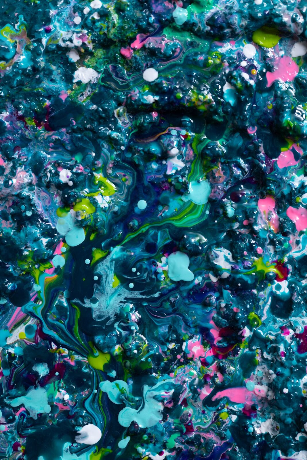 A painting of a heart made out of paint splatters on a black background.