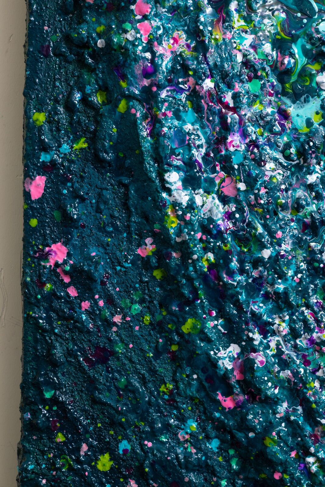 A painting of a heart made out of paint splatters on a black background.