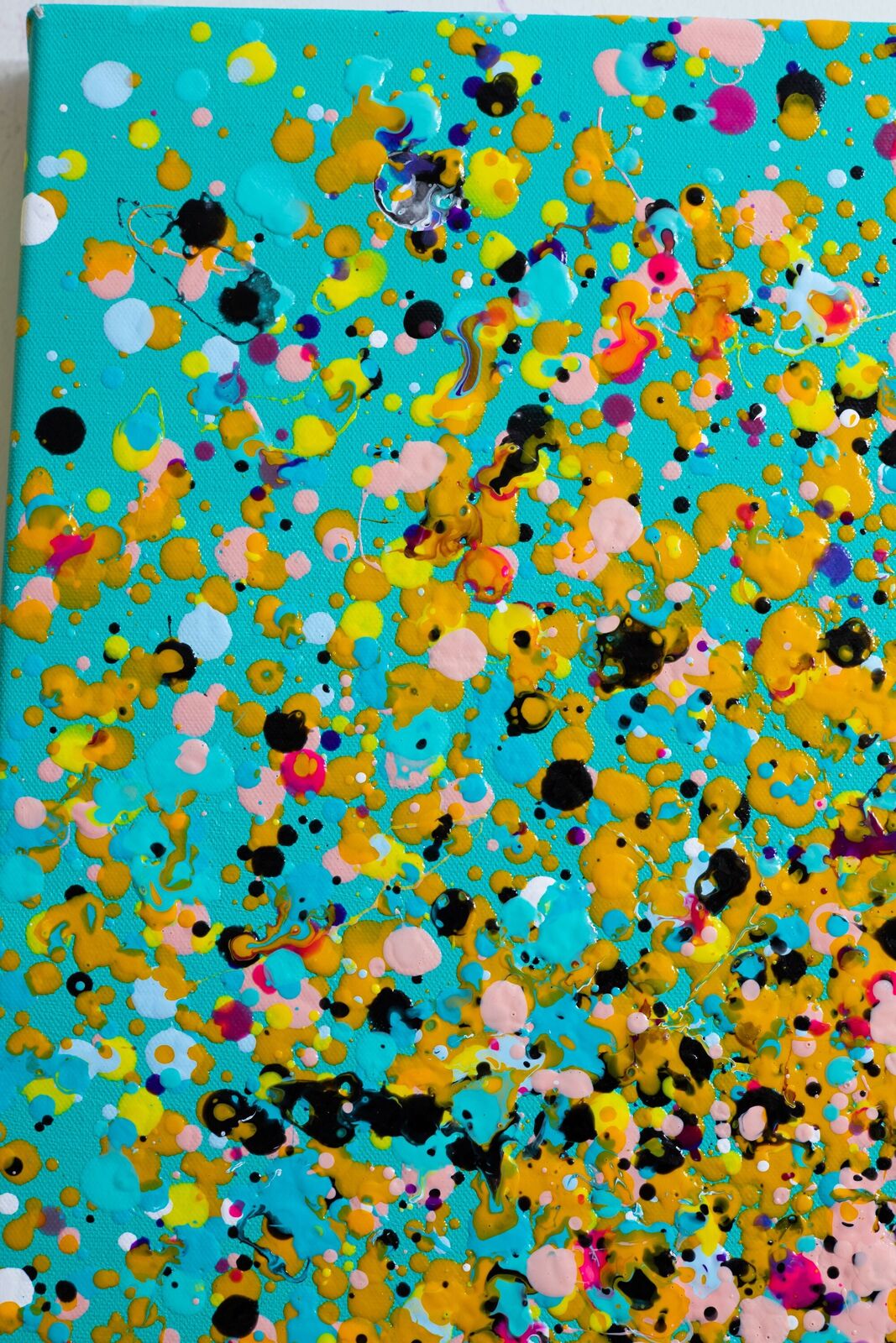 A painting of colorful confetti on a blue background.