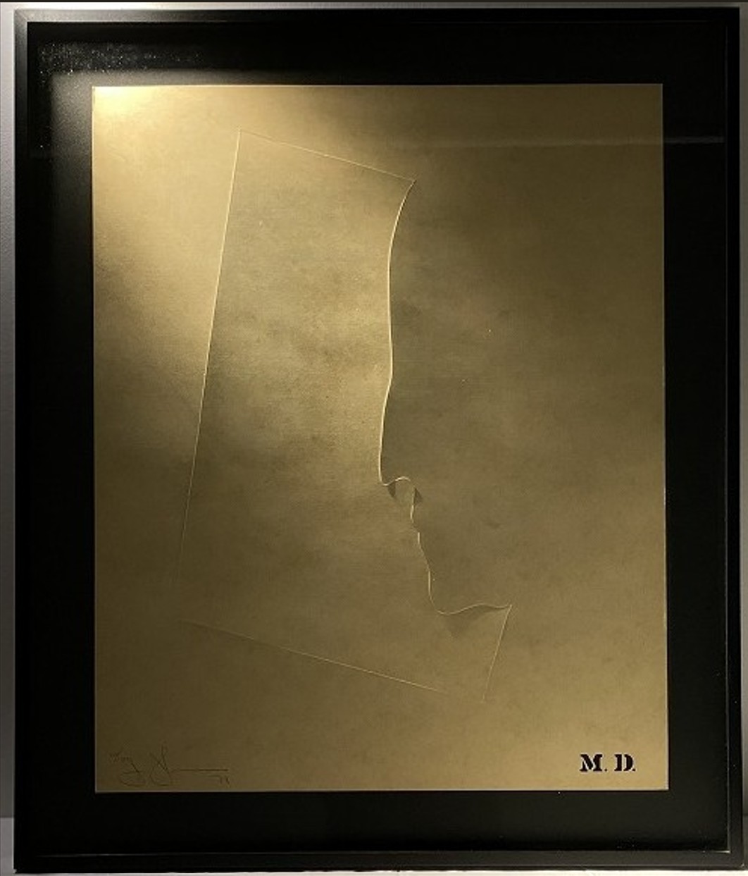 A minimalist gold-toned portrait of a face in profile, framed and illuminated by warm light.
