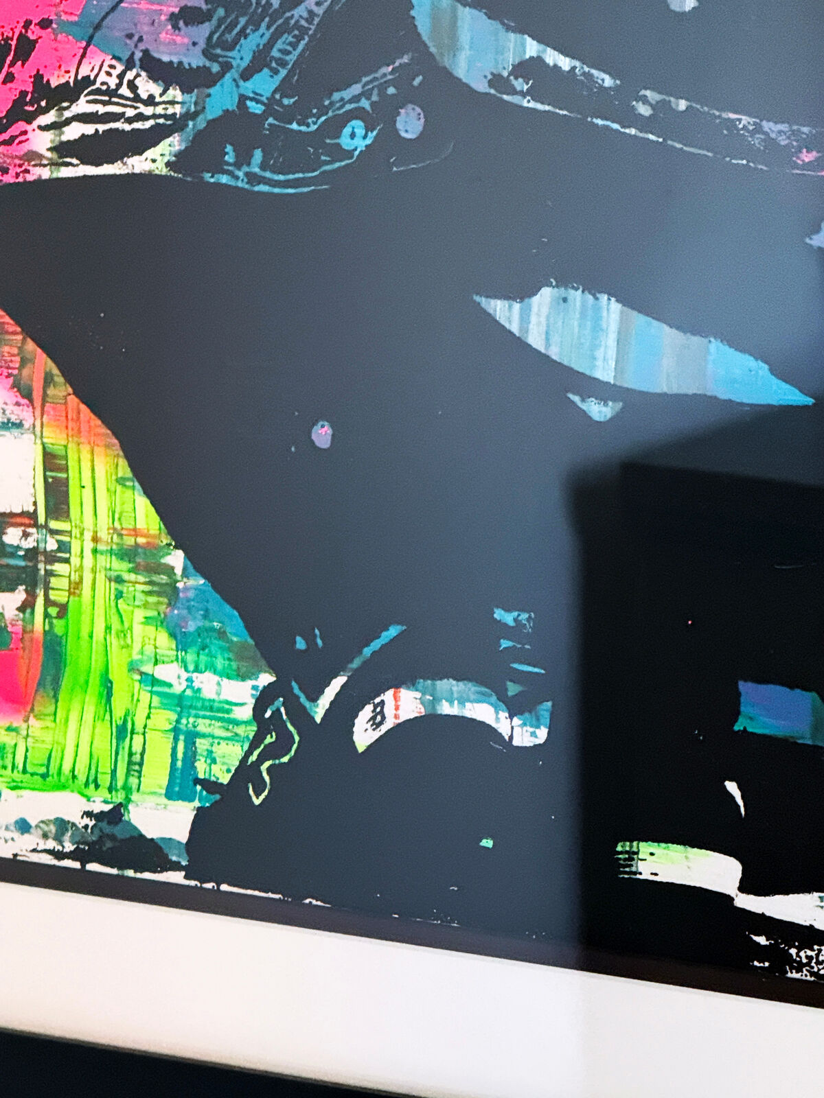 A picture of a painting hanging on a wall in a room.