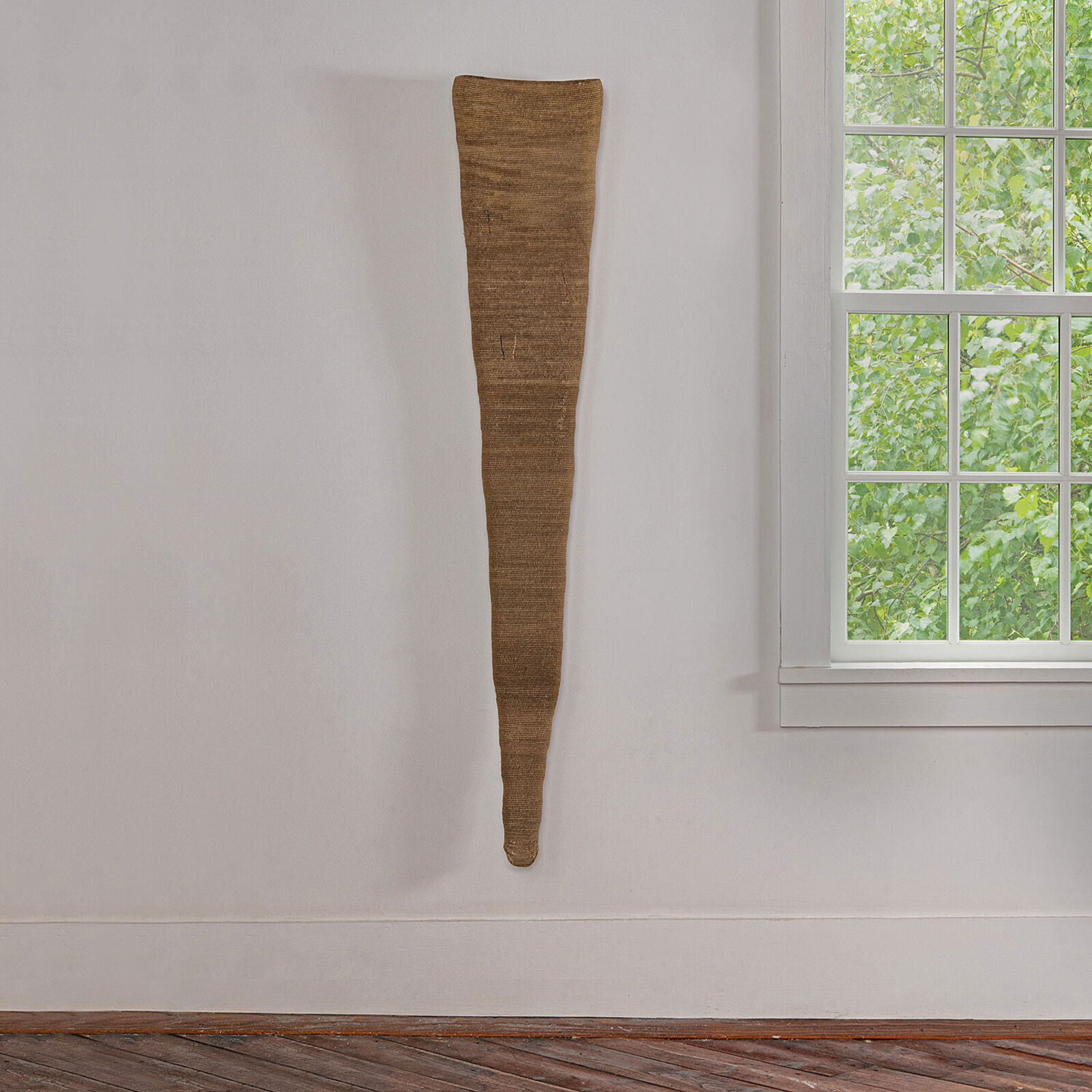 A vase sitting on a shelf next to a window.