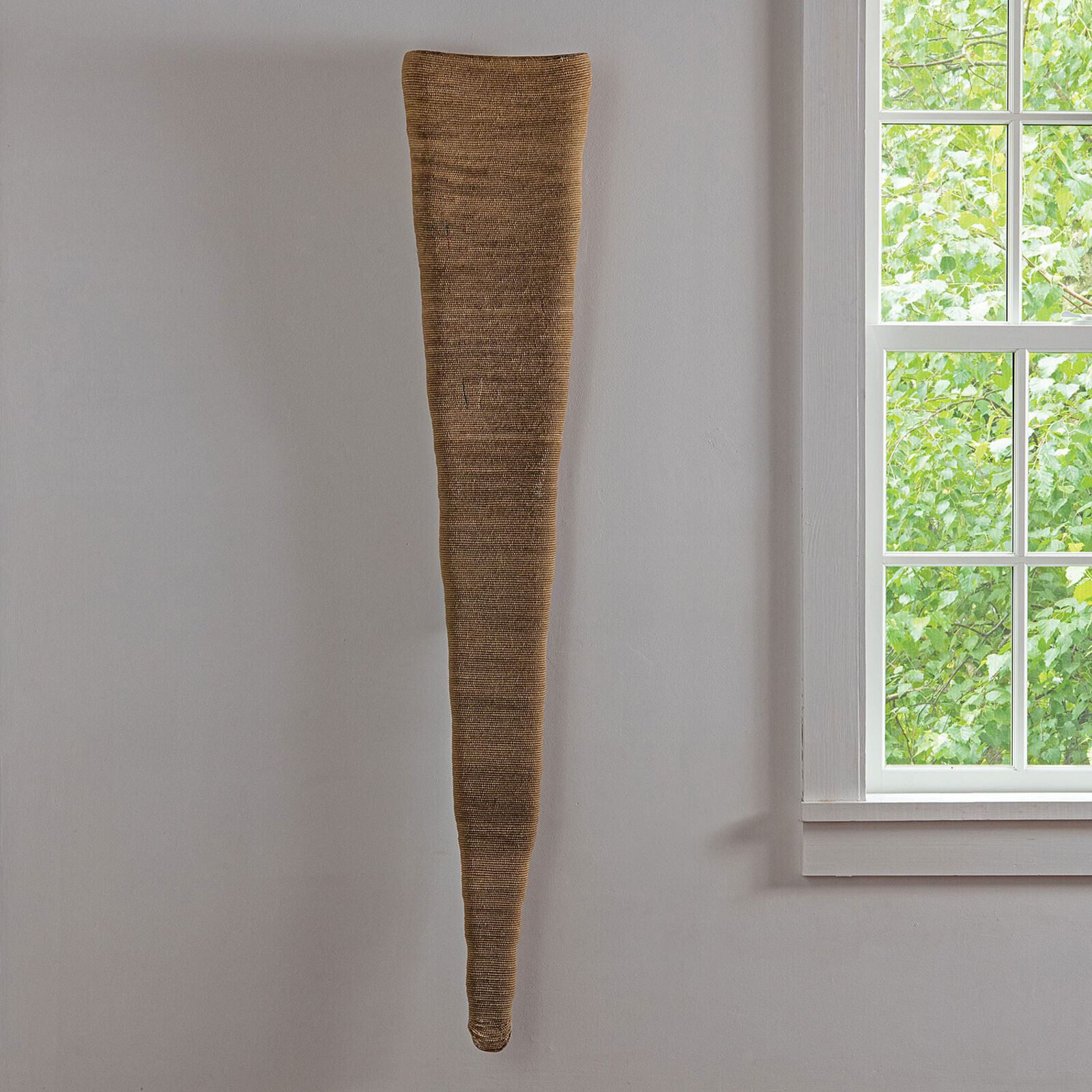 A vase sitting on a shelf next to a window.
