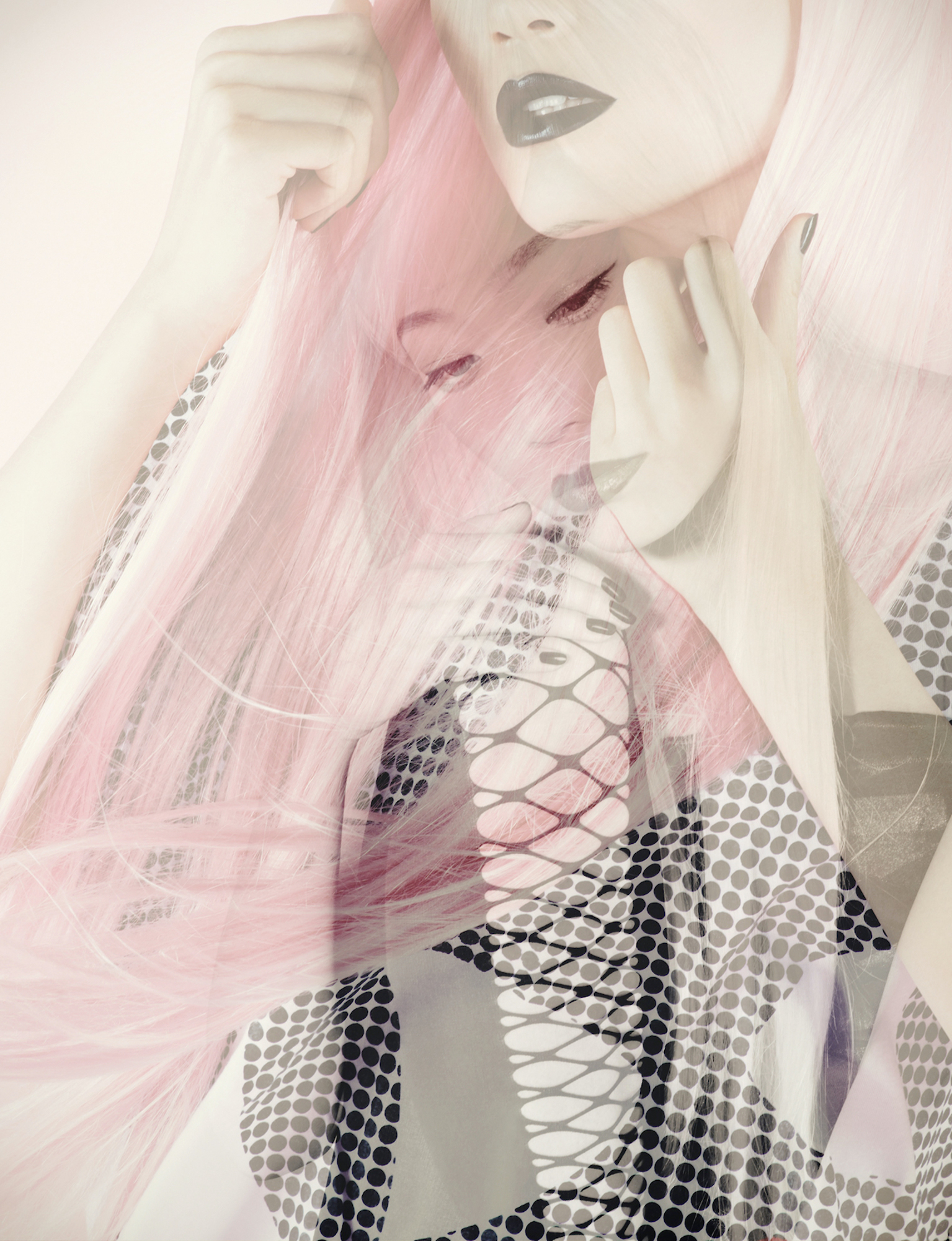 A woman with pink hair and a fishnet top.