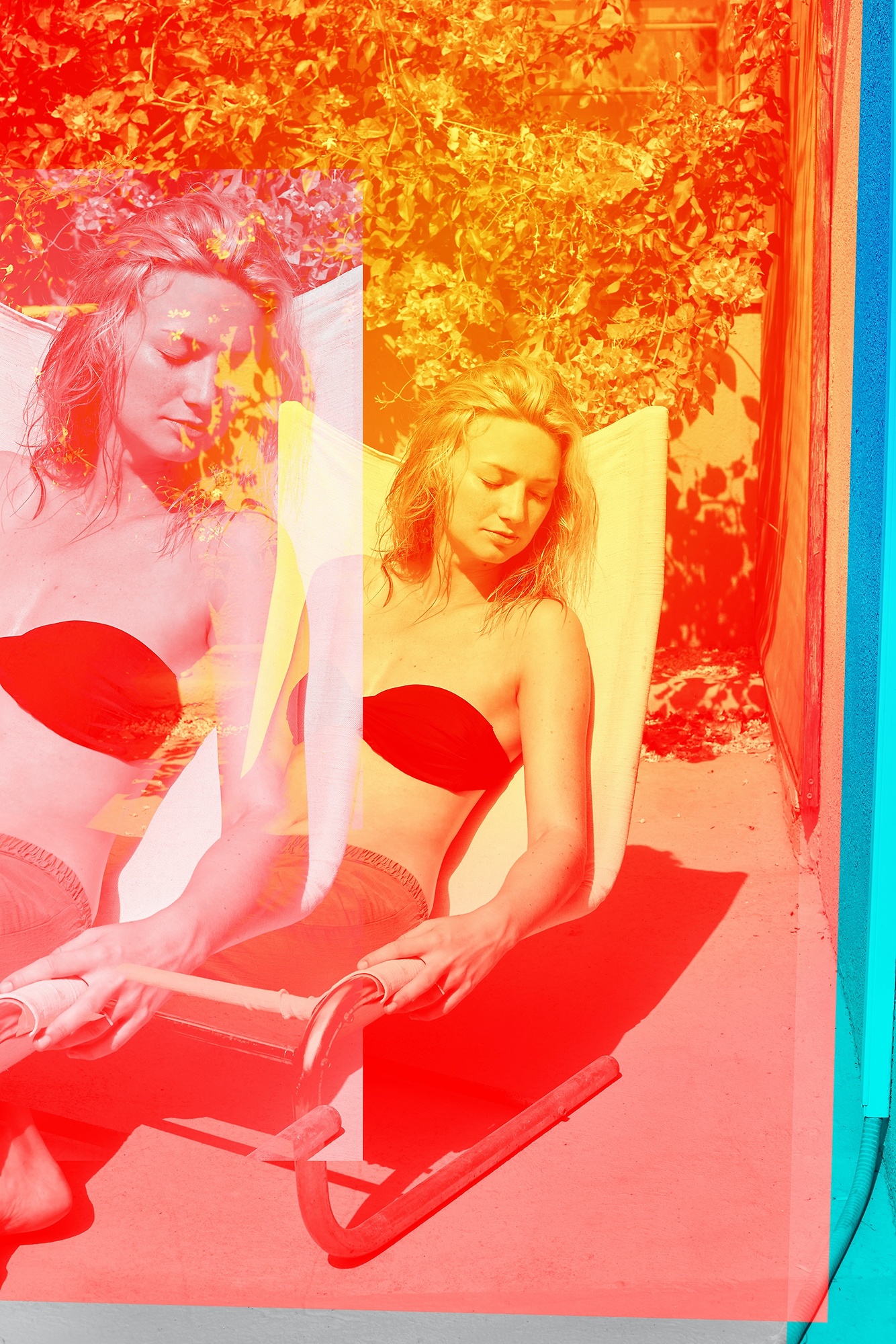 A woman in a red bikini sitting on a beach chair.