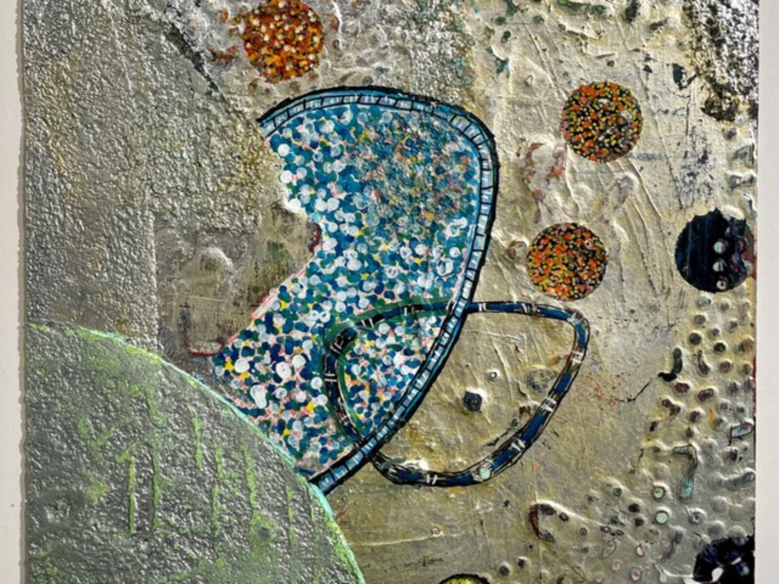 A painting of a blue hat on a wall.