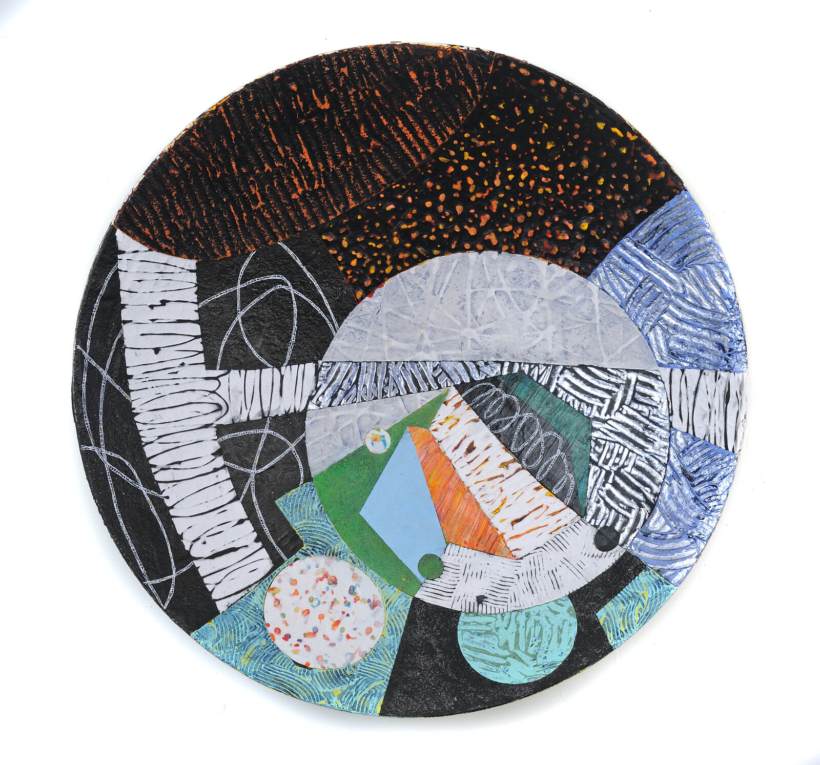 A circular piece of art on a white surface.