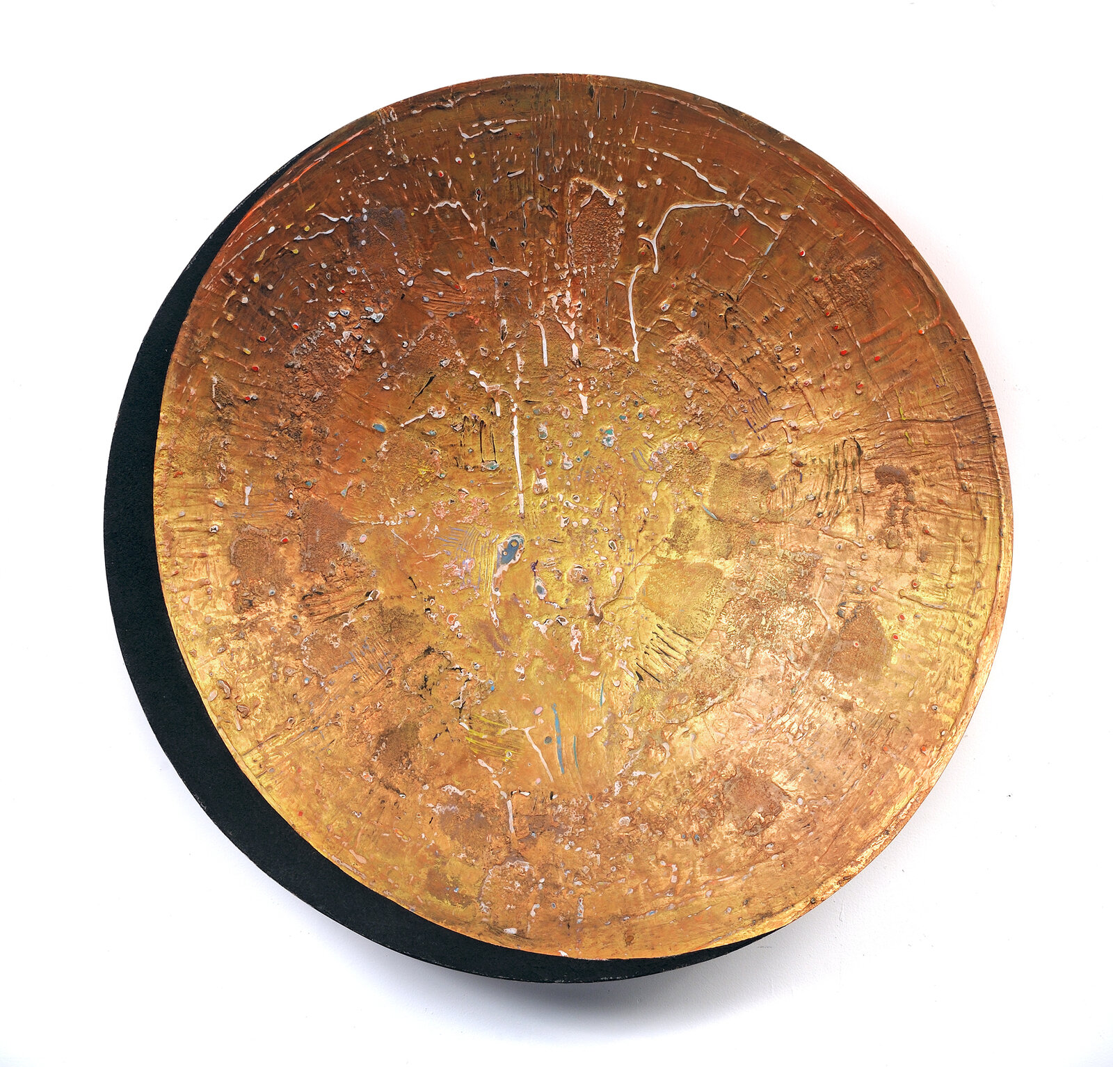 A round copper plate with a black base on a white background.