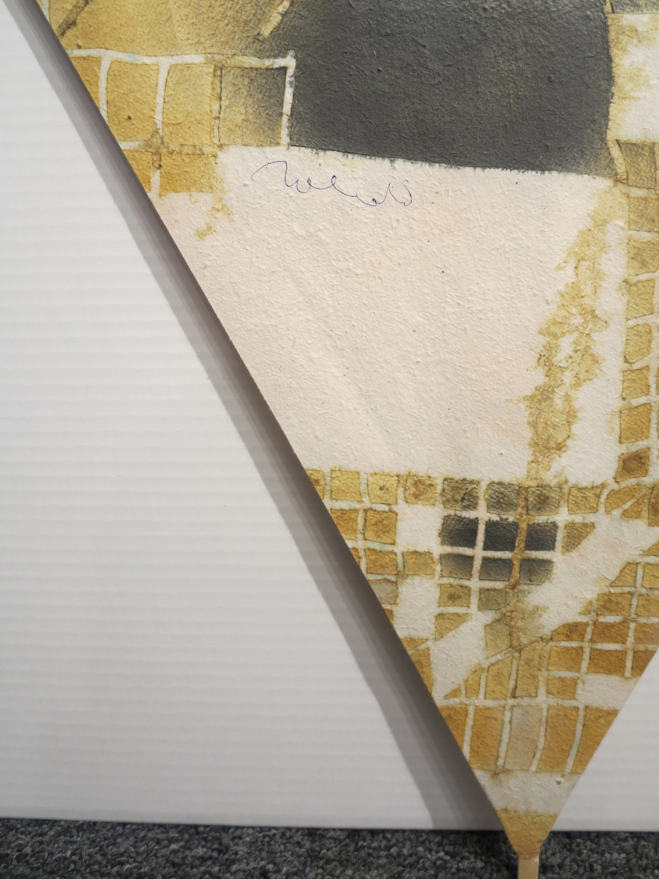 A painting of a snake on a piece of paper on a wall.