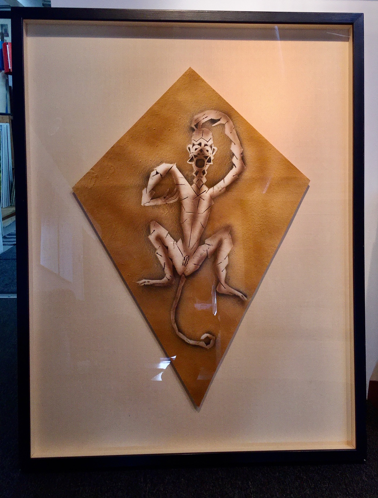 A paper cut out of a lizard on a piece of paper.