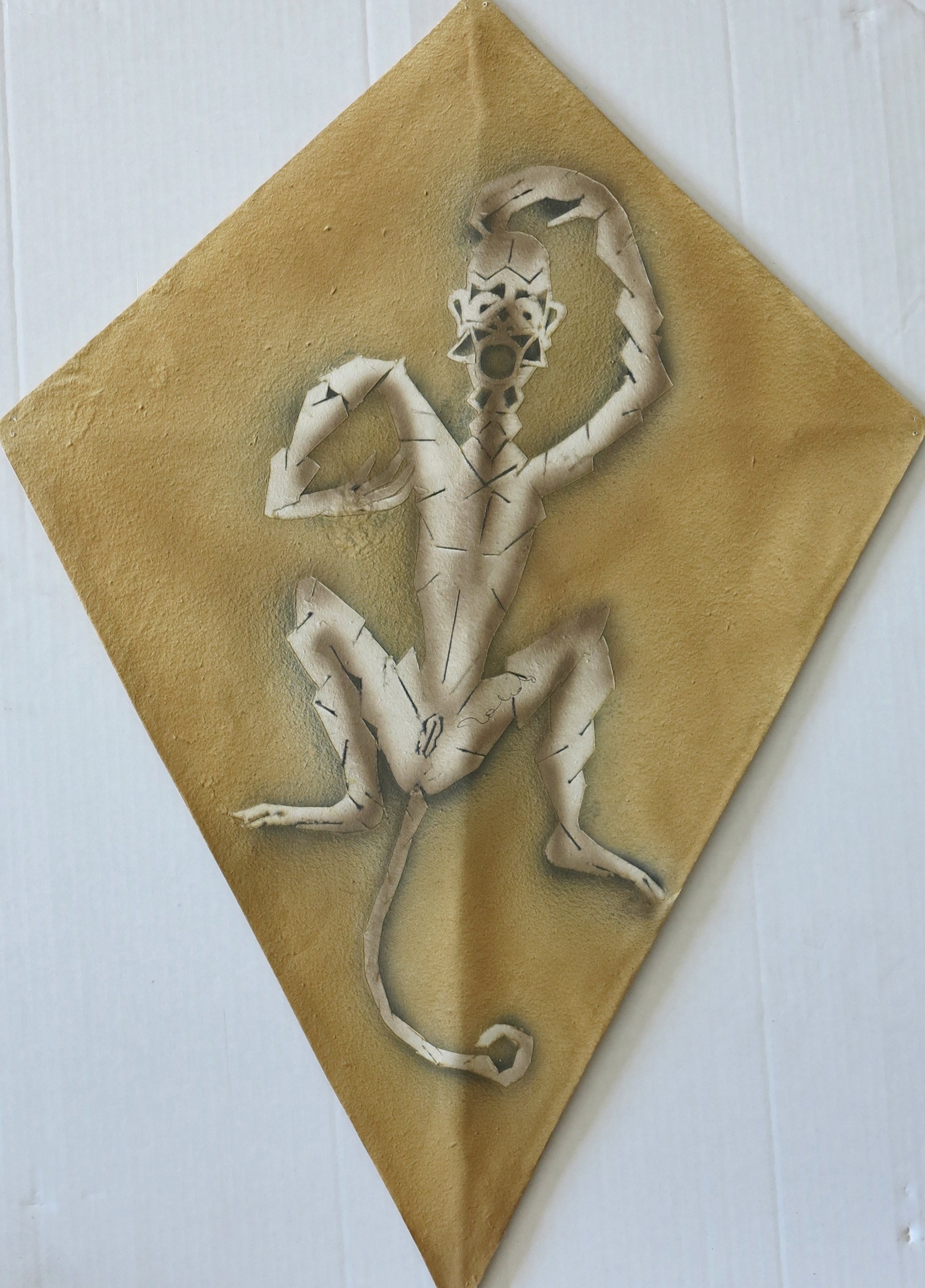 A paper cut out of a lizard on a piece of paper.