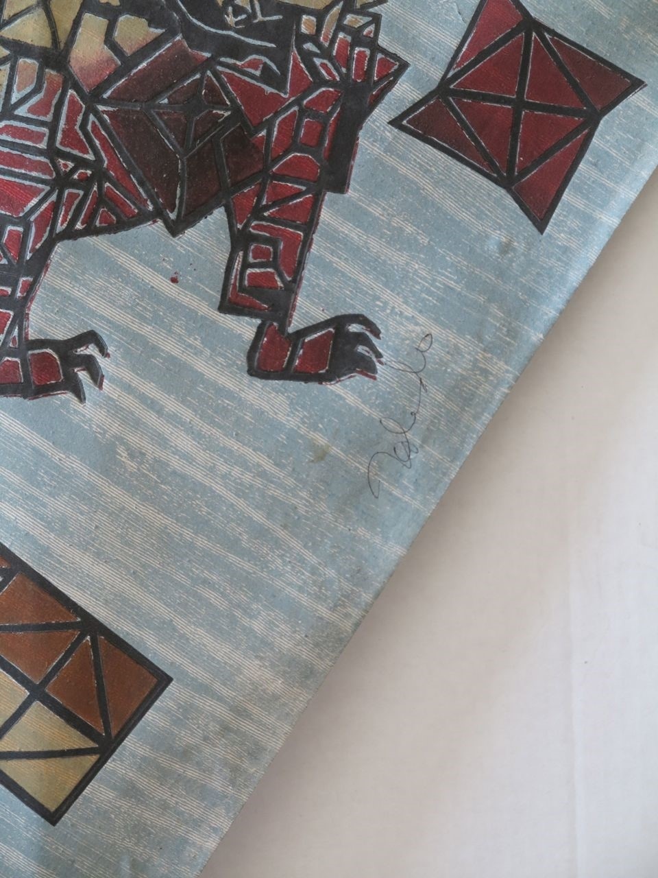 A painting of a rhino on a piece of wood.