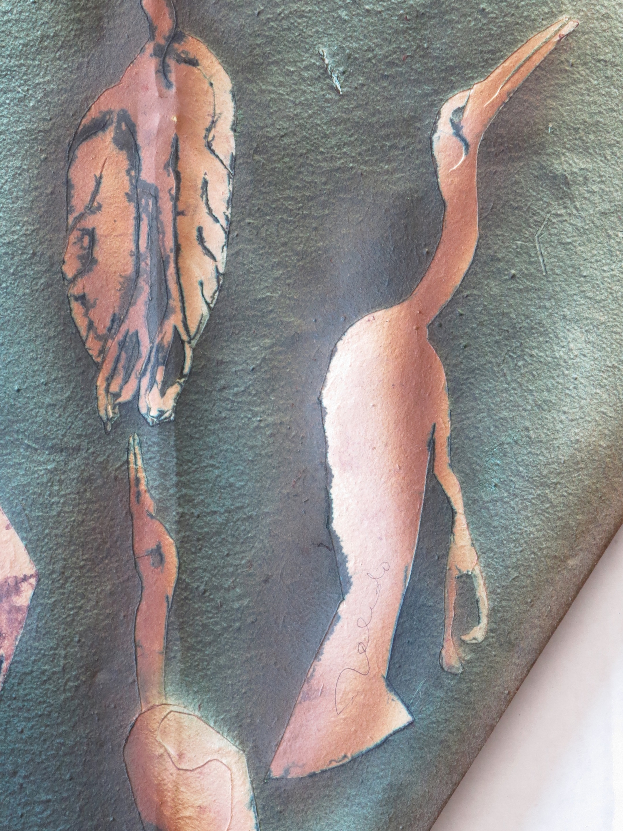 A metal sculpture of three birds on a green background.