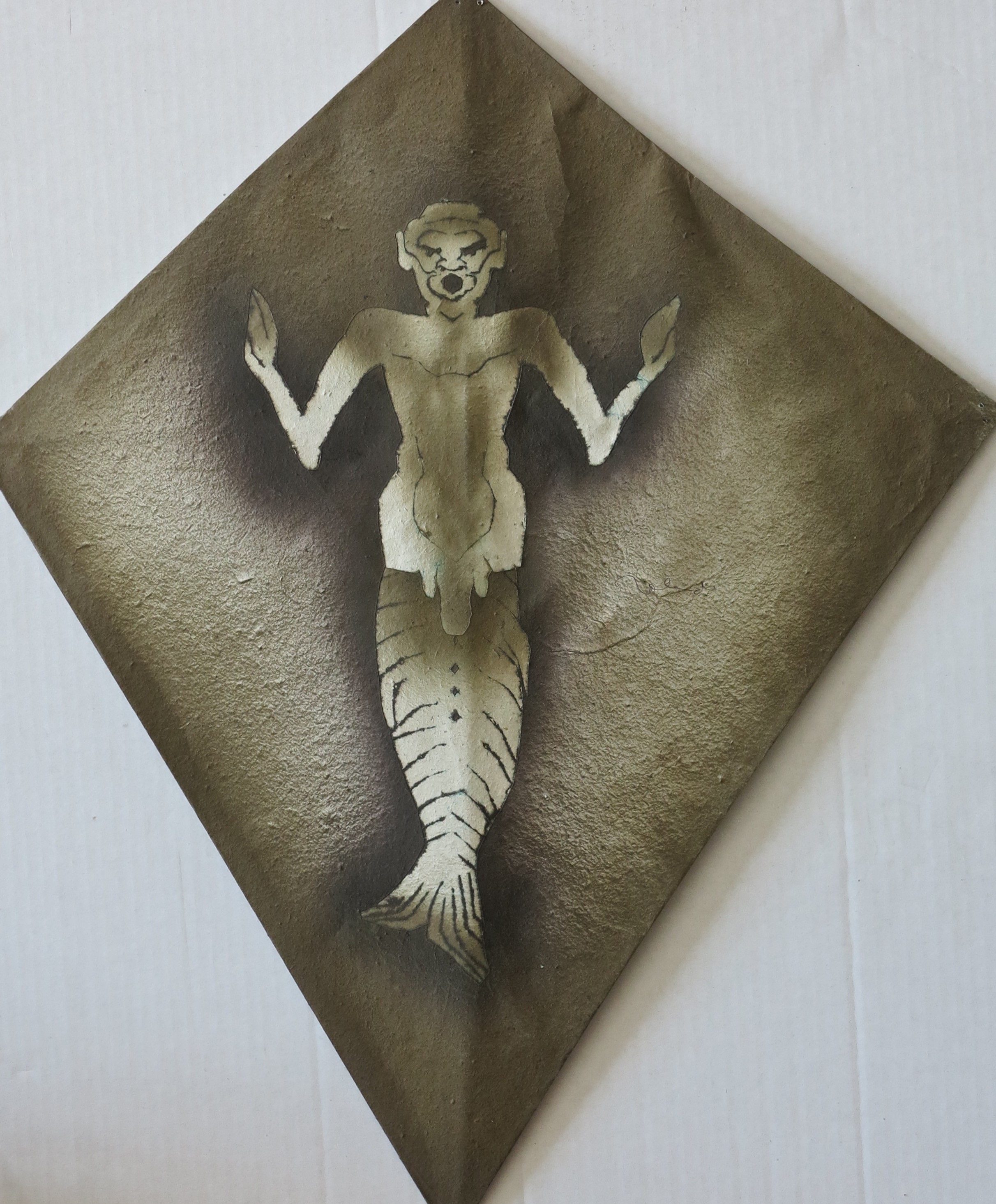 A painting of a mermaid on a piece of paper.