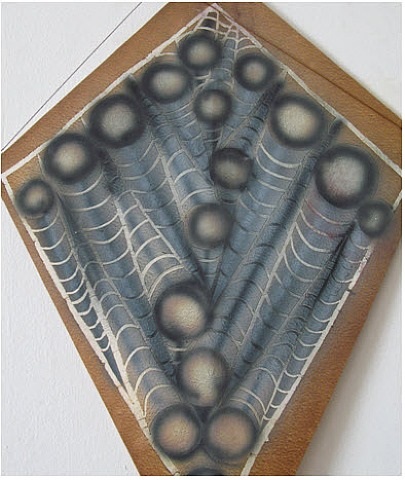 A close up of a piece of art on a wall.