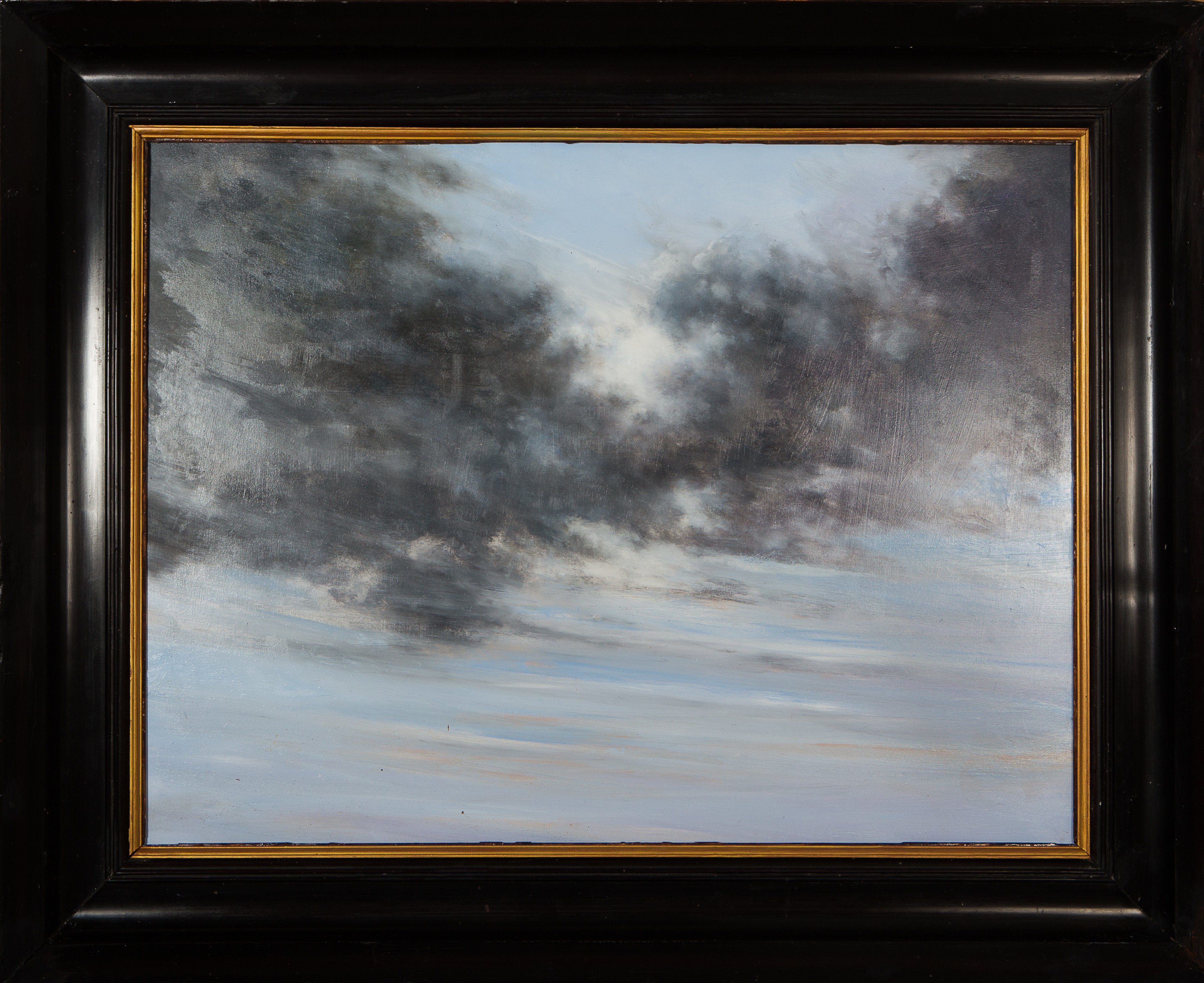 A painting of a cloudy sky in a black frame.