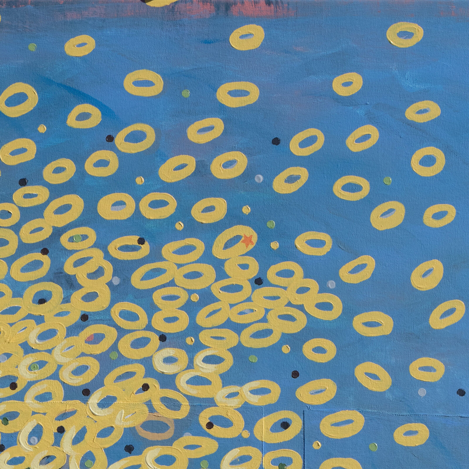 A painting on a wall with a blue background and yellow circles.
