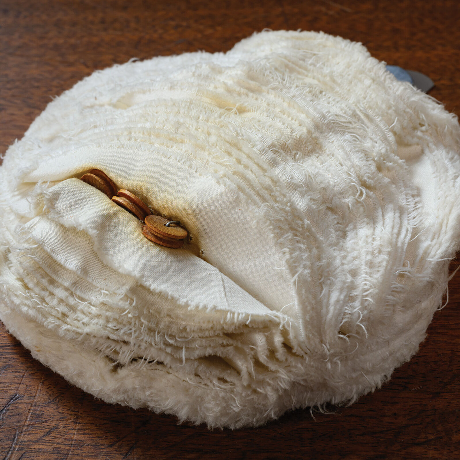 A white ball of yarn sitting on top of a table.