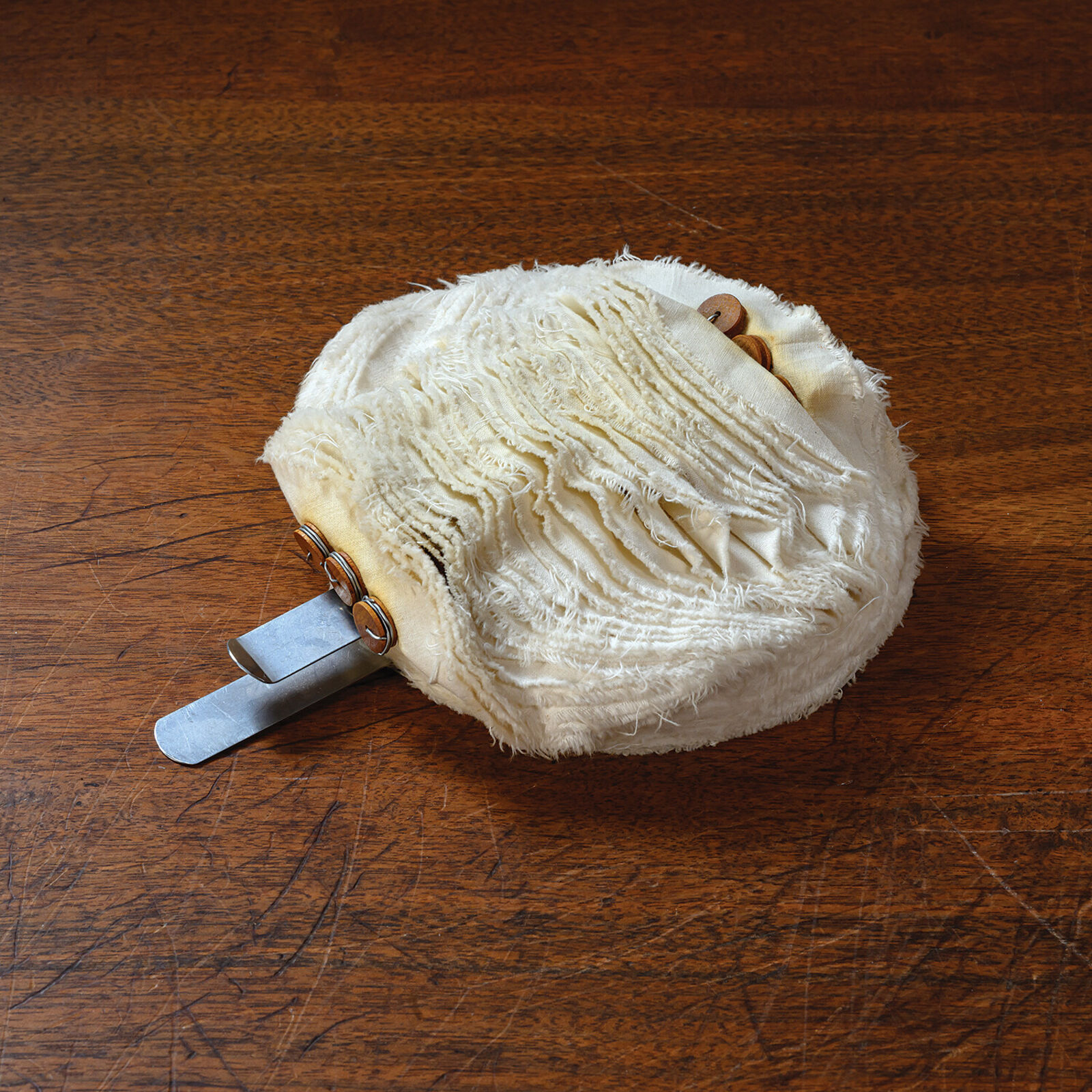 A white ball of yarn sitting on top of a table.
