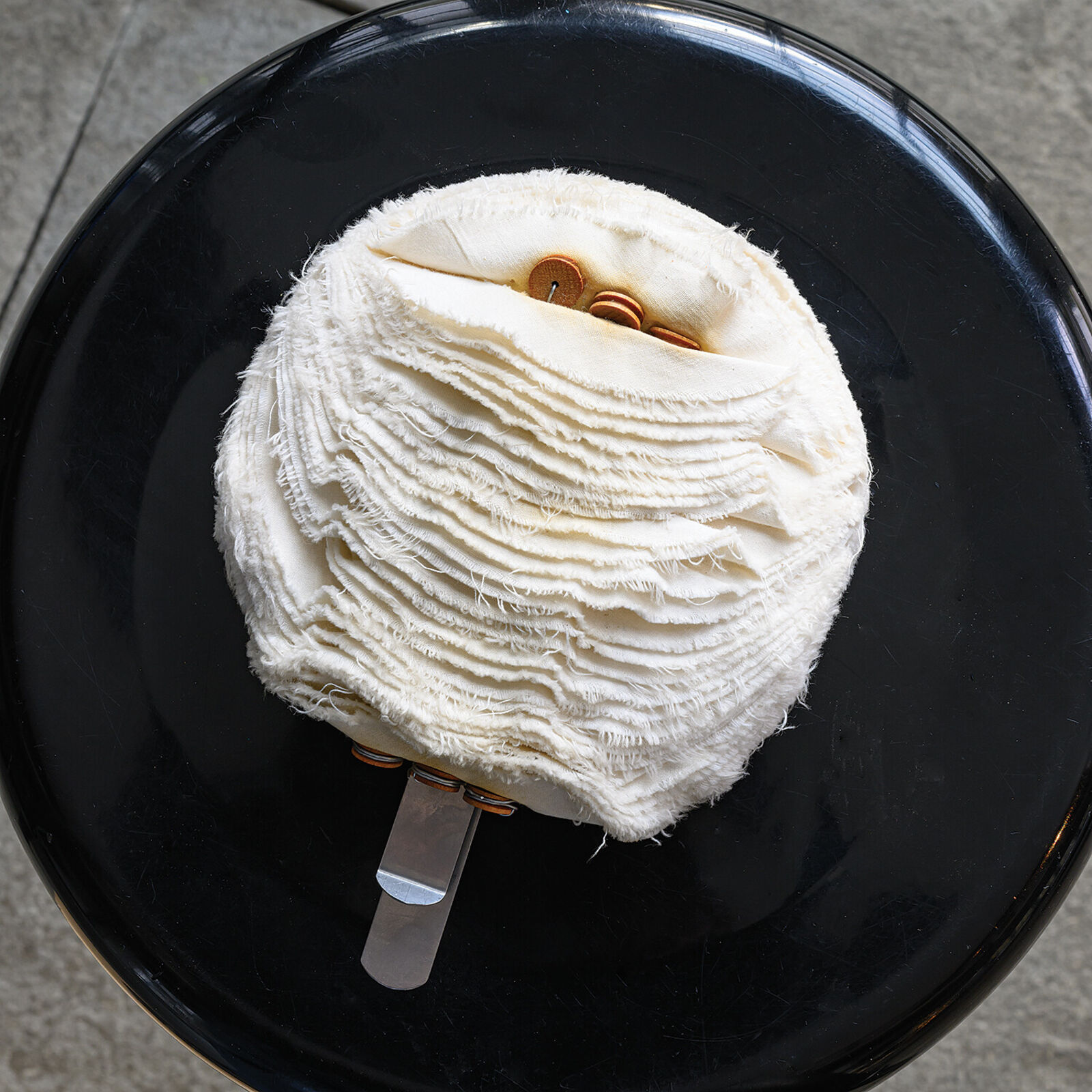 A white ball of yarn sitting on top of a table.