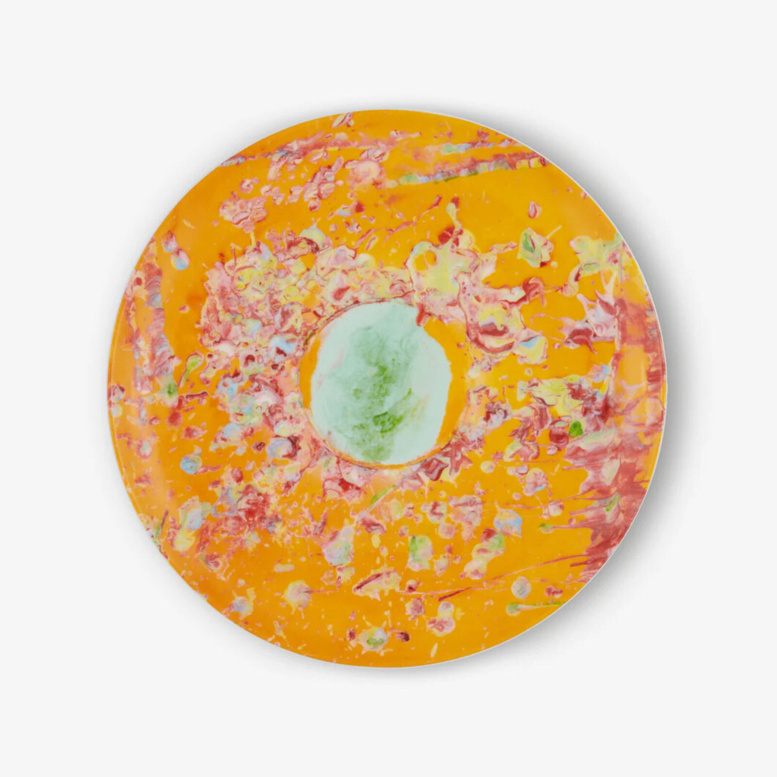 A plate with a painting on it on a white background.