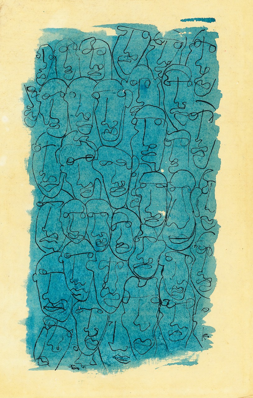 A drawing of a group of faces on a piece of paper.