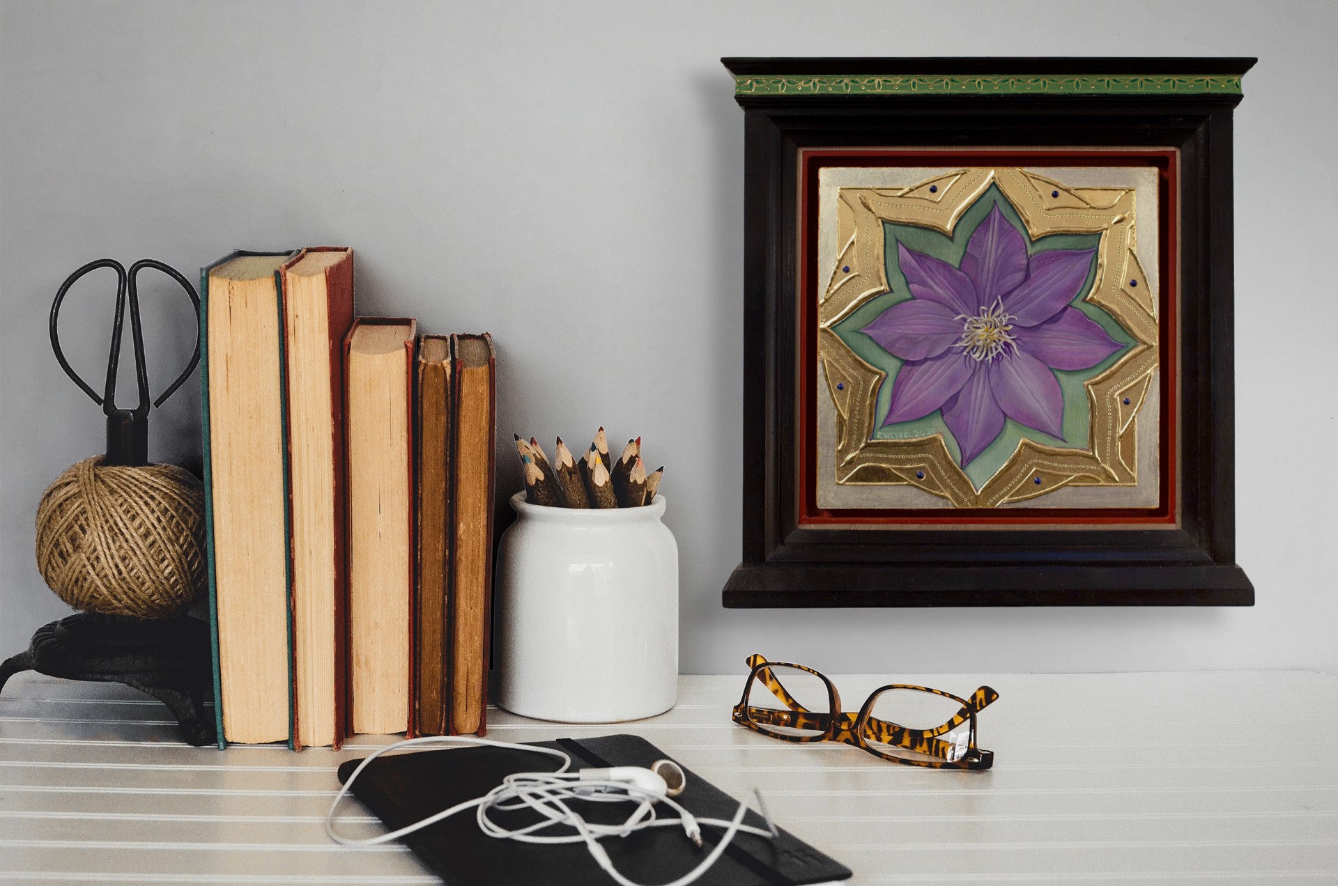 A purple flower set within an ornate gold frame on a red background.