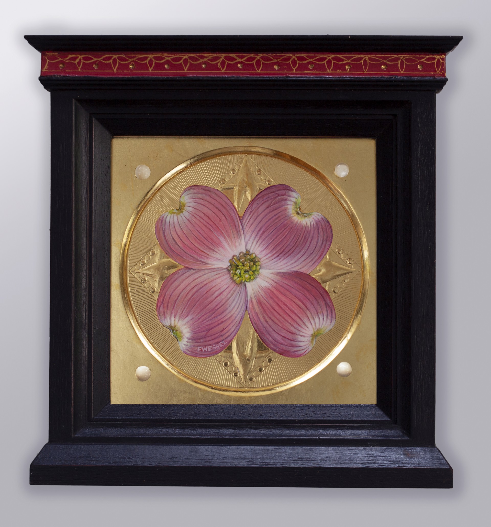 A pink dogwood flower on a gold plate with pearls.