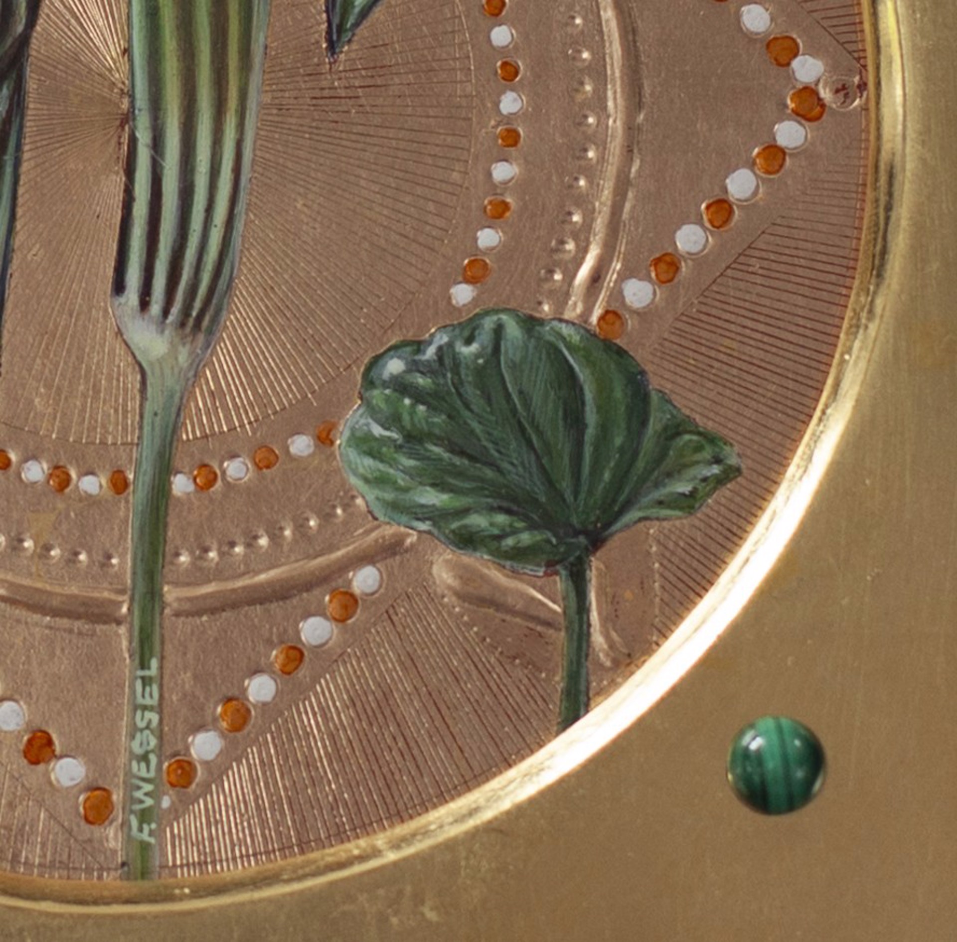 A picture of two flowers on a gold plate.