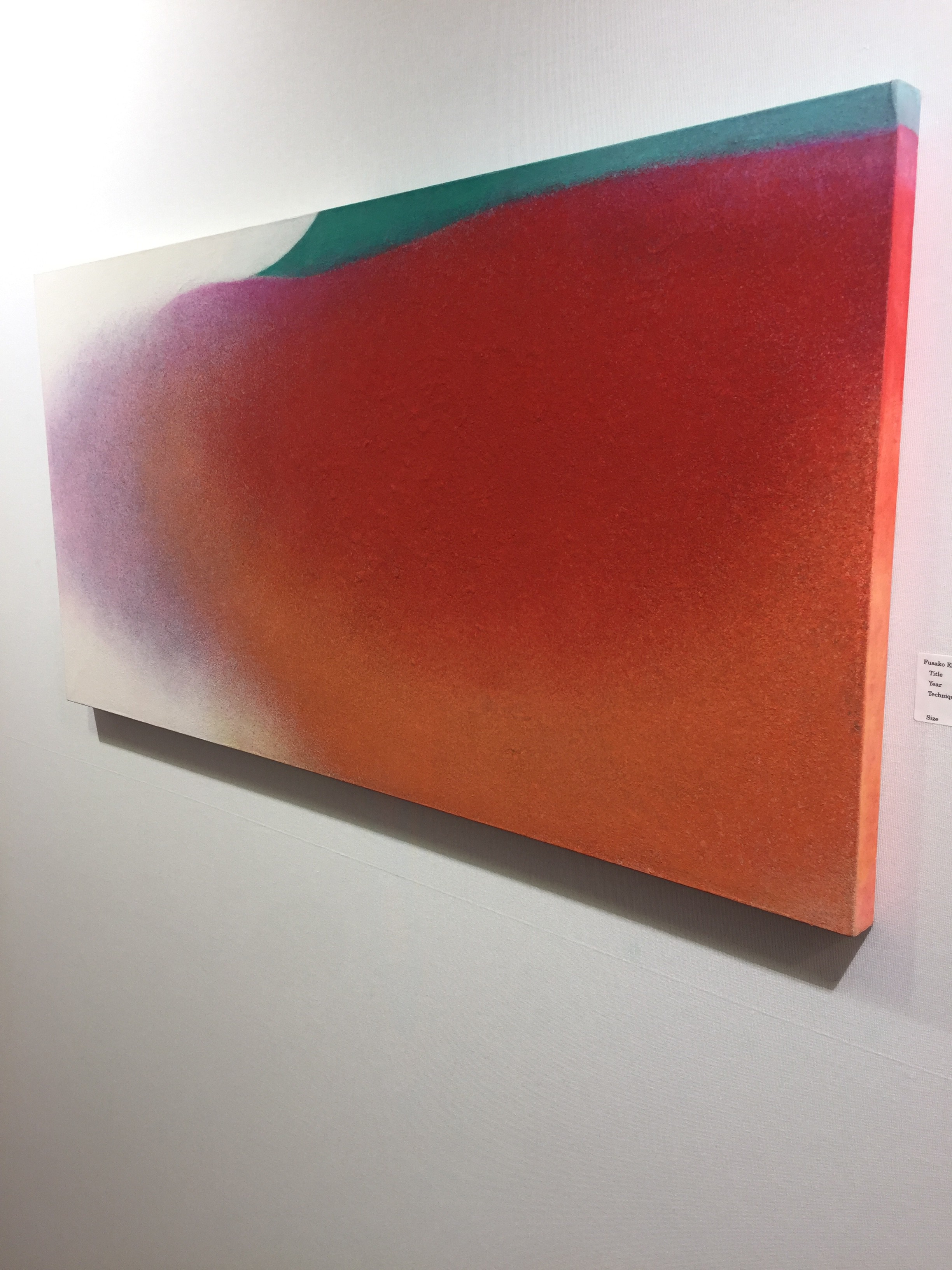 A painting hanging on a wall in a room.