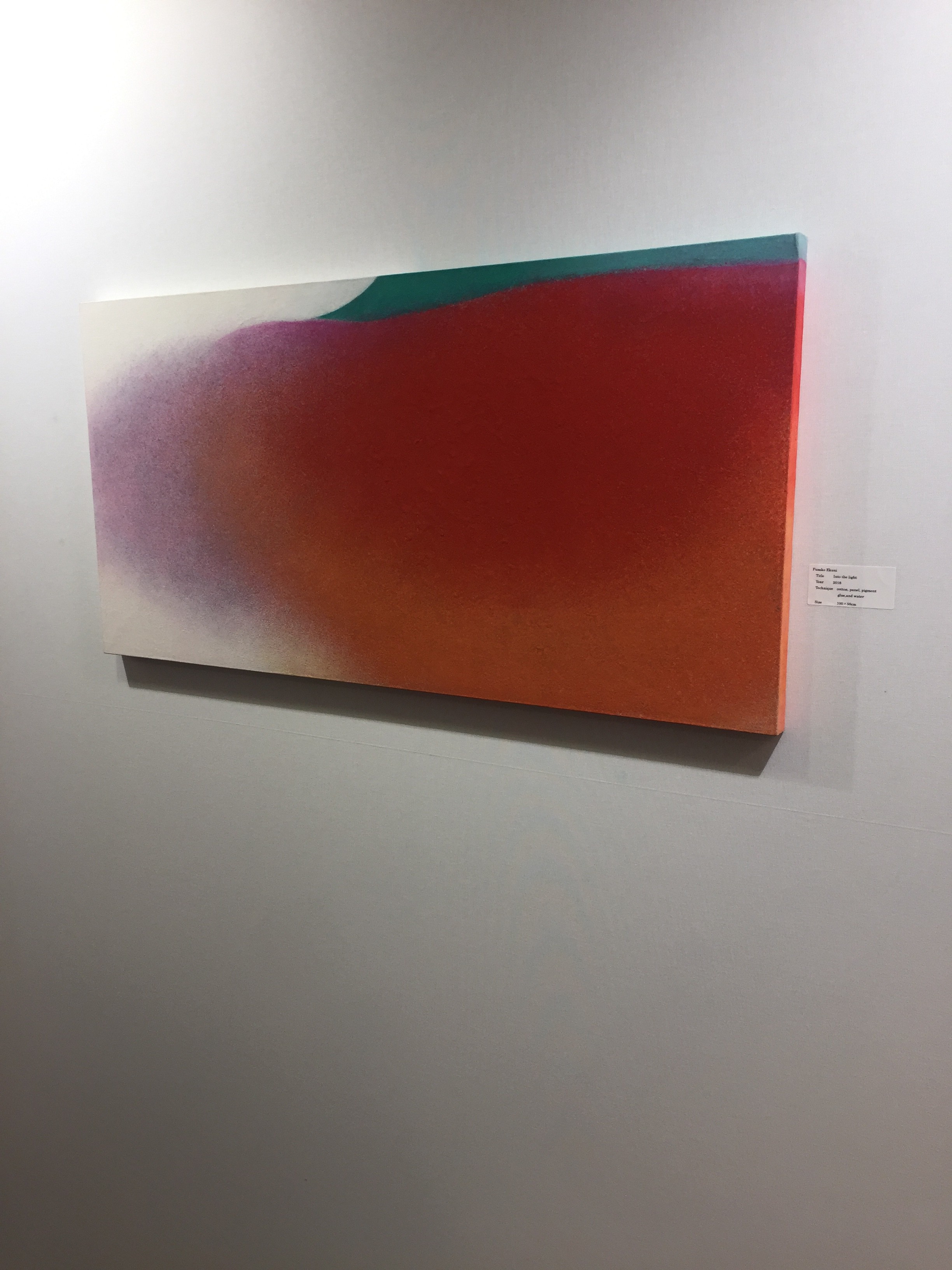 A painting hanging on a wall in a room.