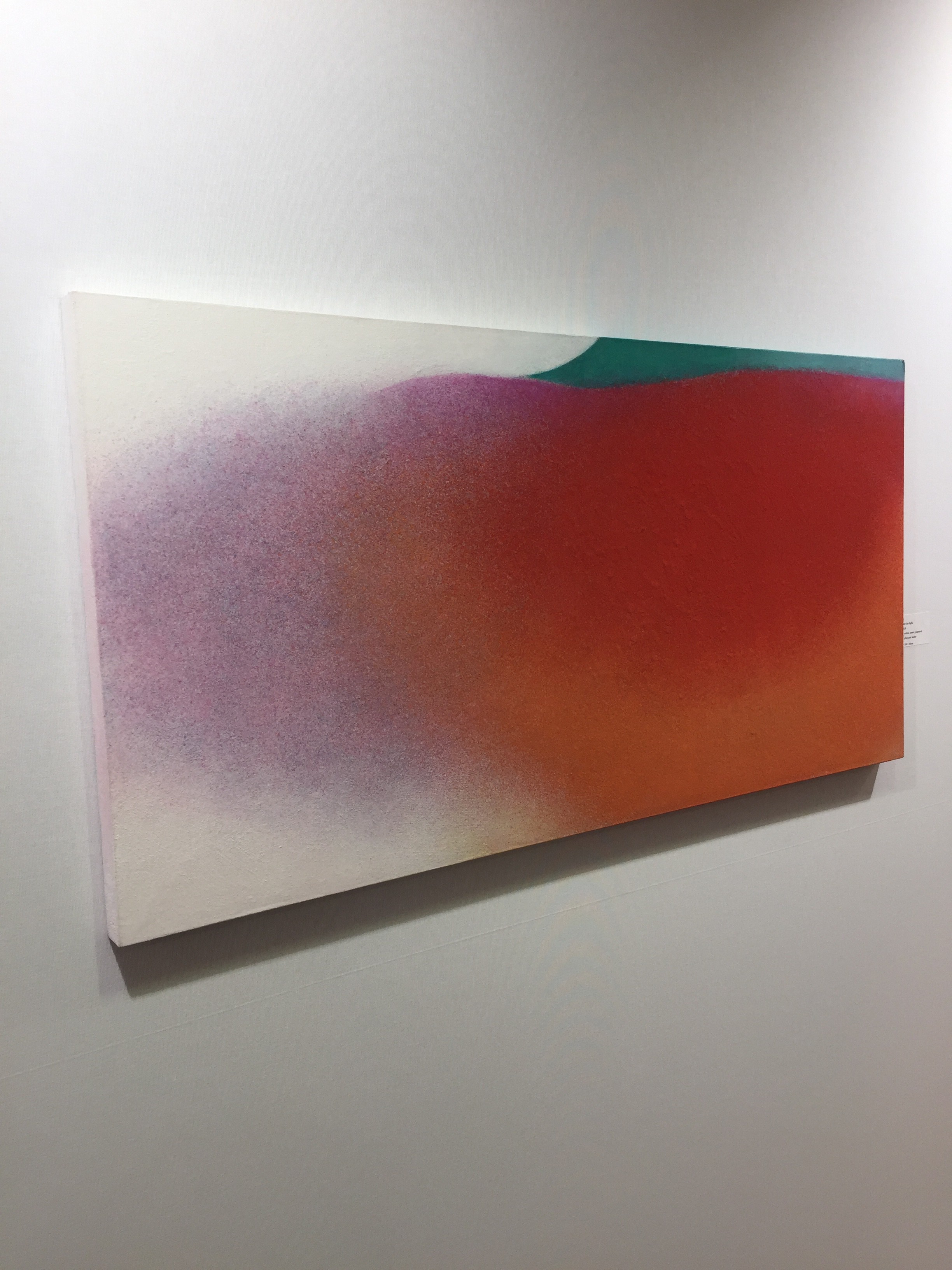 A painting hanging on a wall in a room.