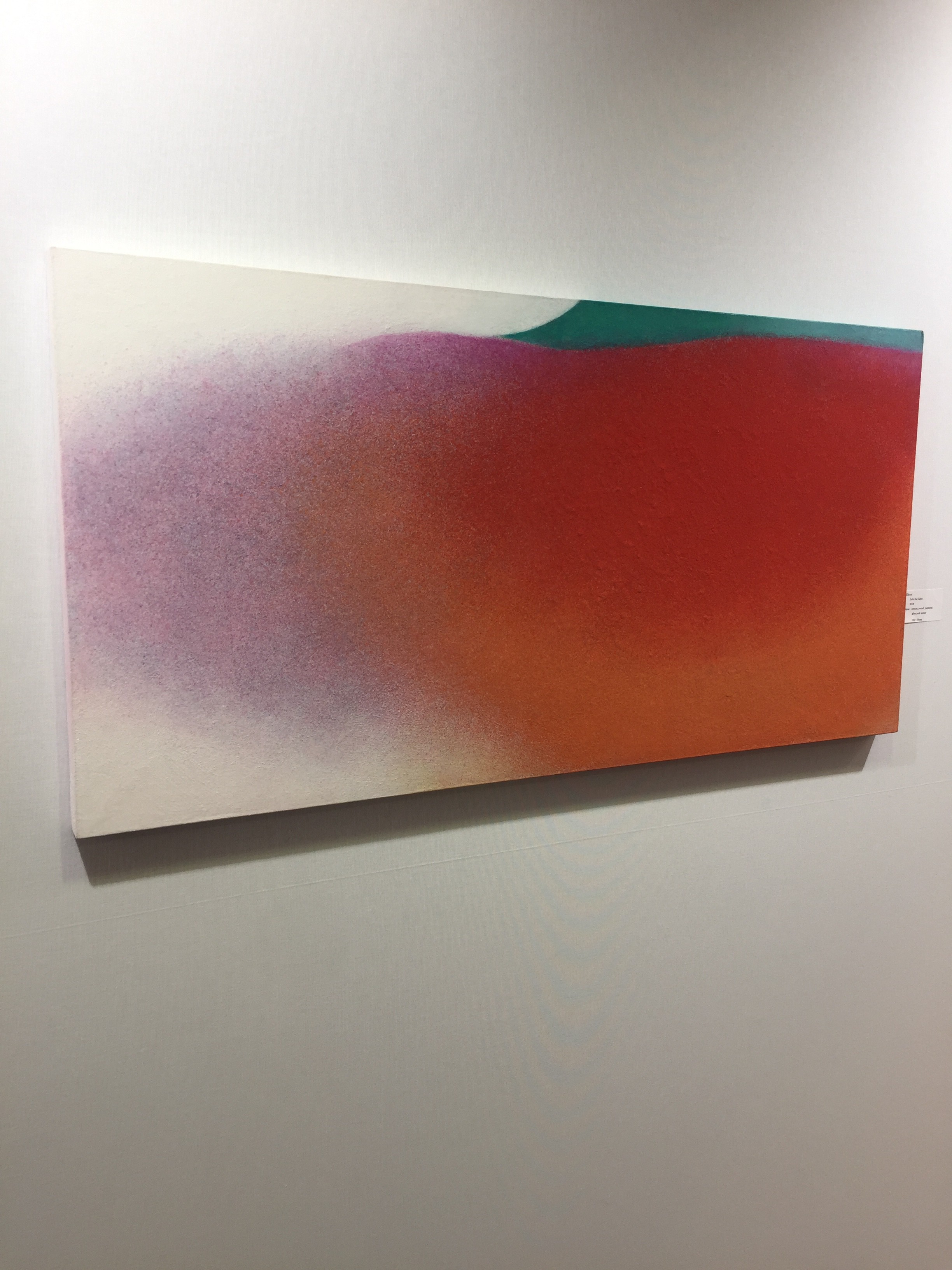 A painting hanging on a wall in a room.