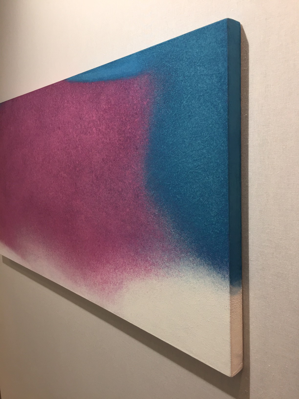 A painting hanging on a wall in a room.
