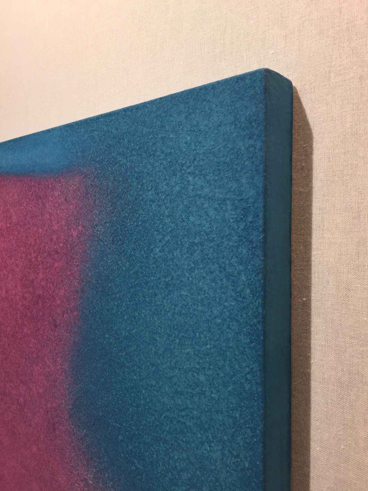 A painting hanging on a wall in a room.
