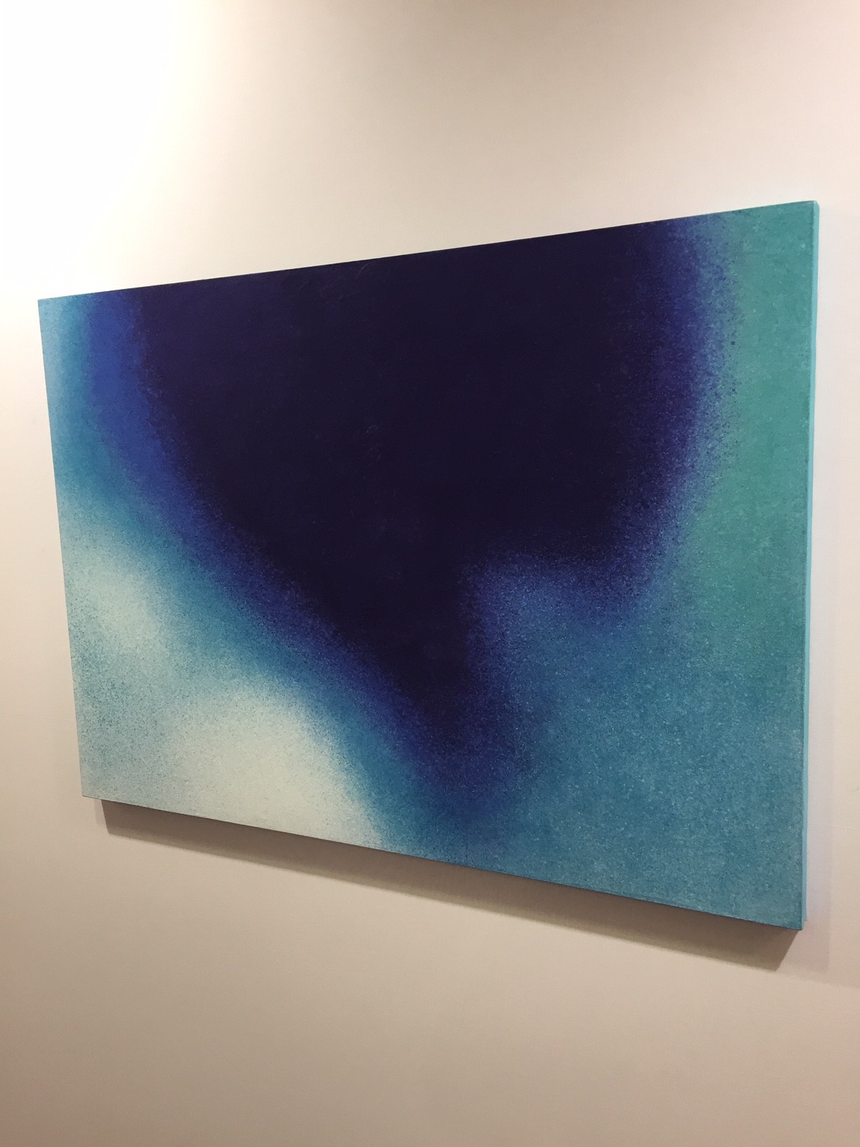 A painting hanging on a wall in a room.