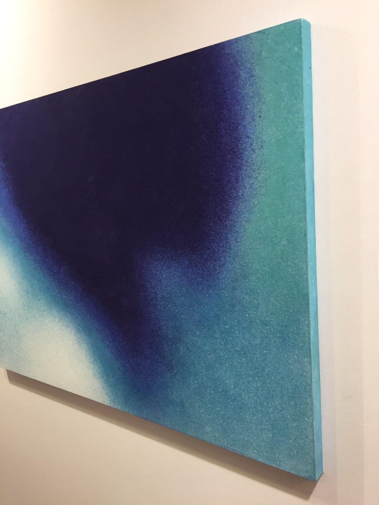 A painting hanging on a wall in a room.