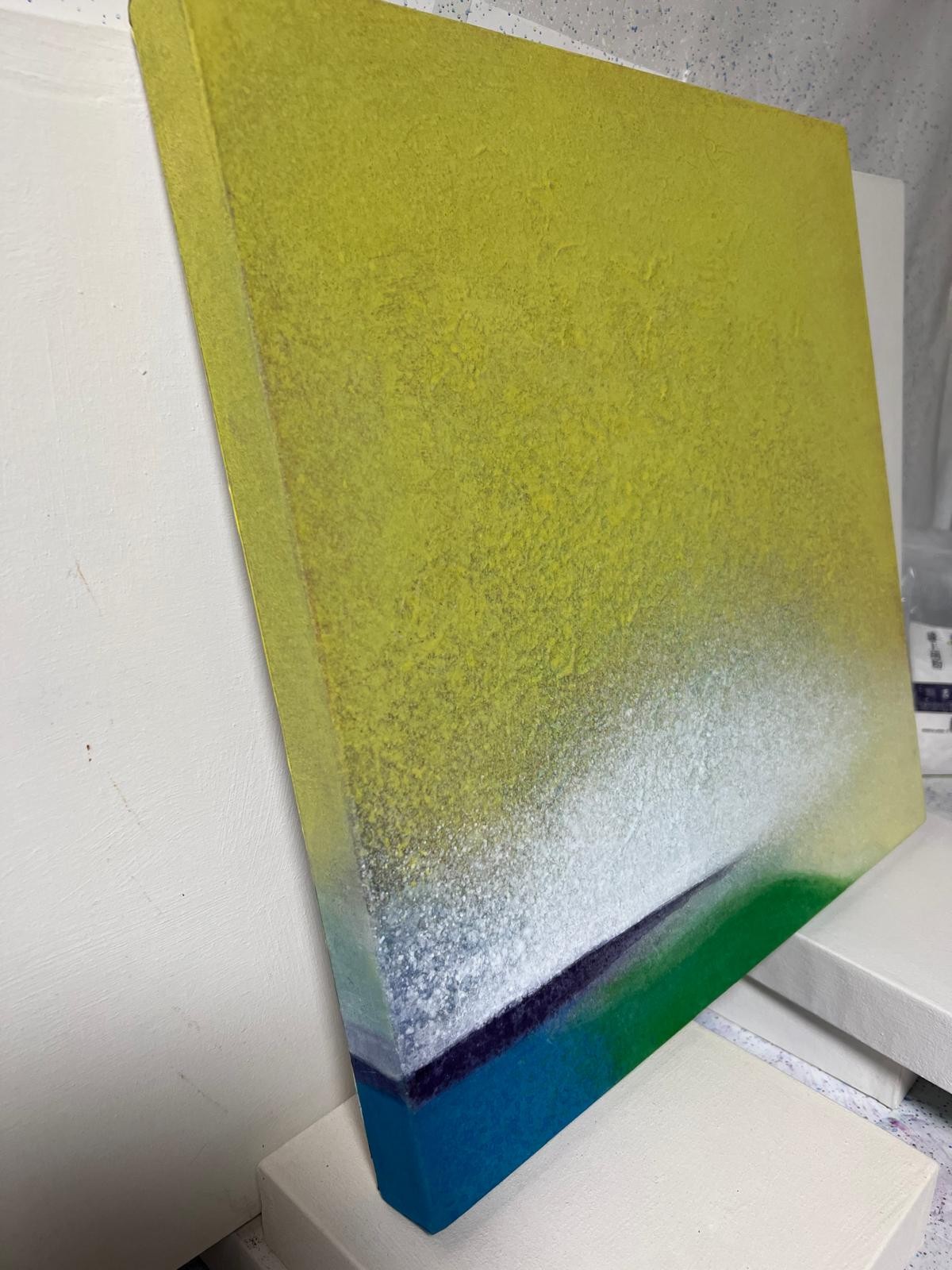 An abstract composition featuring a textured gradient from yellow to white, resting on a dark horizon line with hints of blue and green.