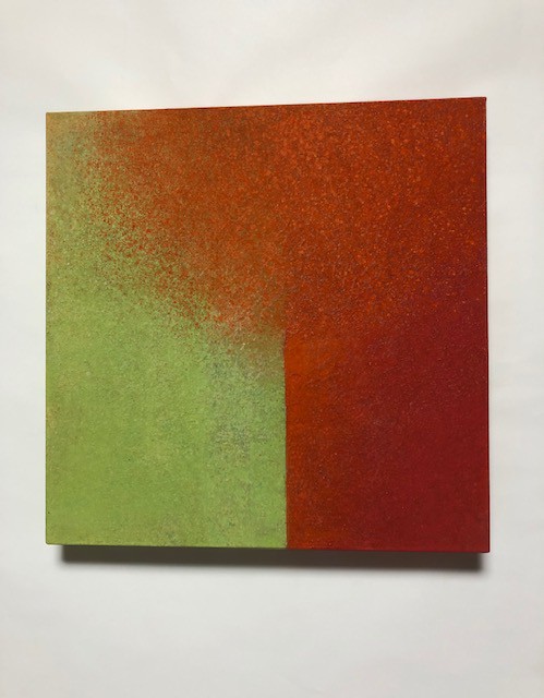 A painting on a white wall with a red and green color block.