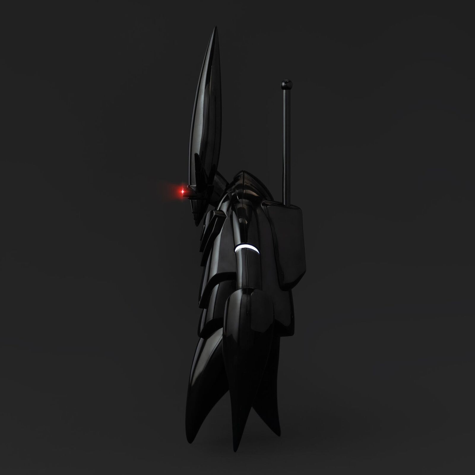 A black and red robot with a red light on it's head.