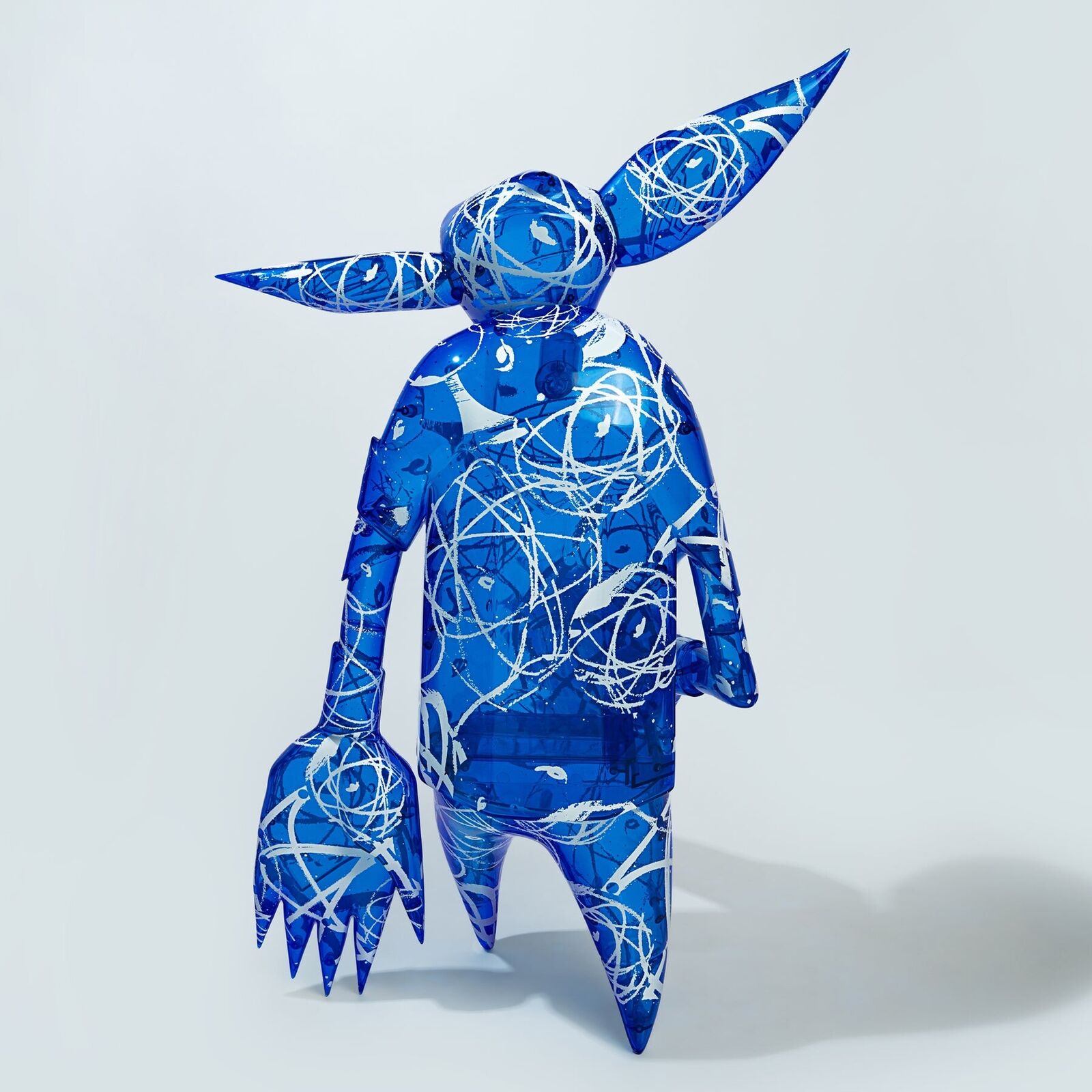 A blue and white sculpture of a man with a hat on his head.