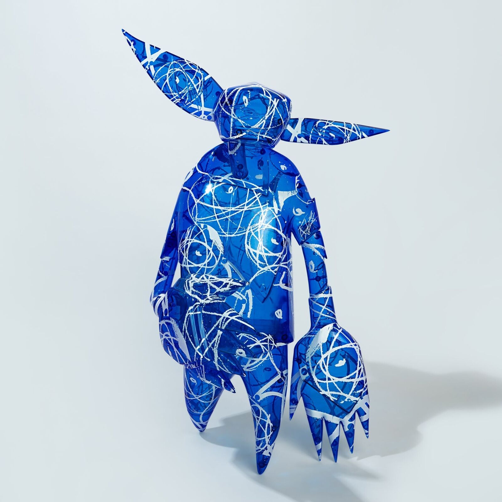 A blue and white sculpture of a man with a hat on his head.