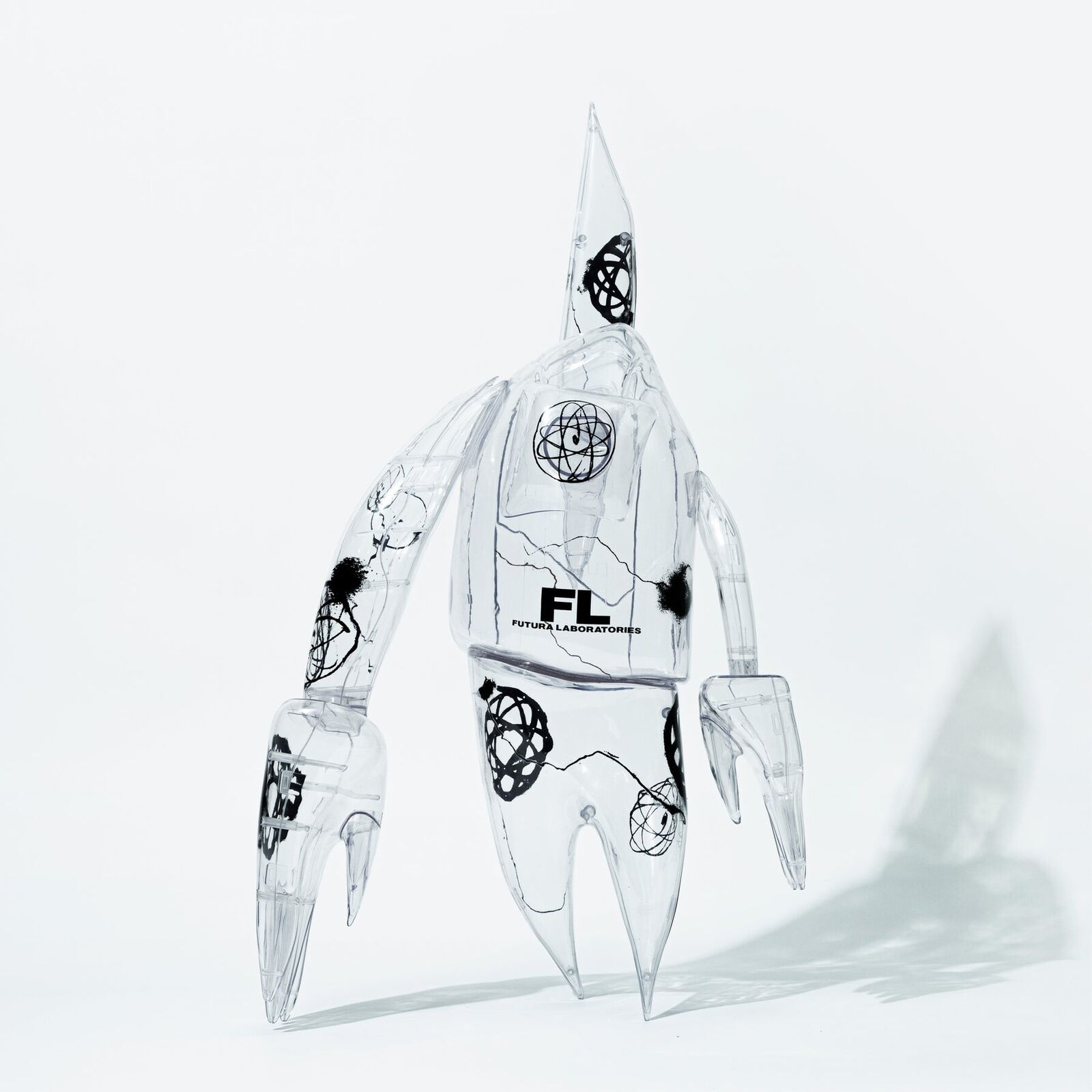 A clear plastic robot with a black and white design on it.