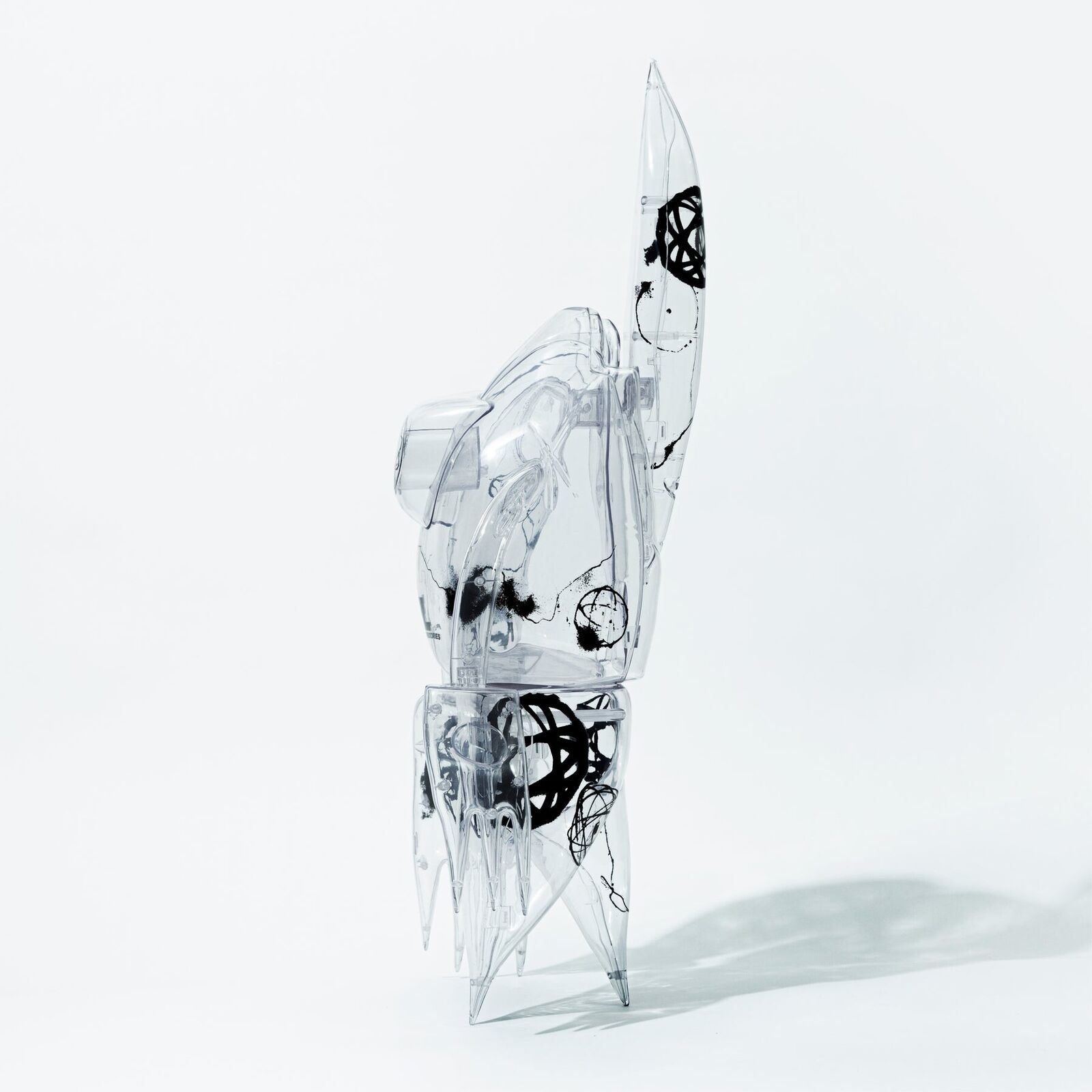 A clear plastic robot with a black and white design on it.