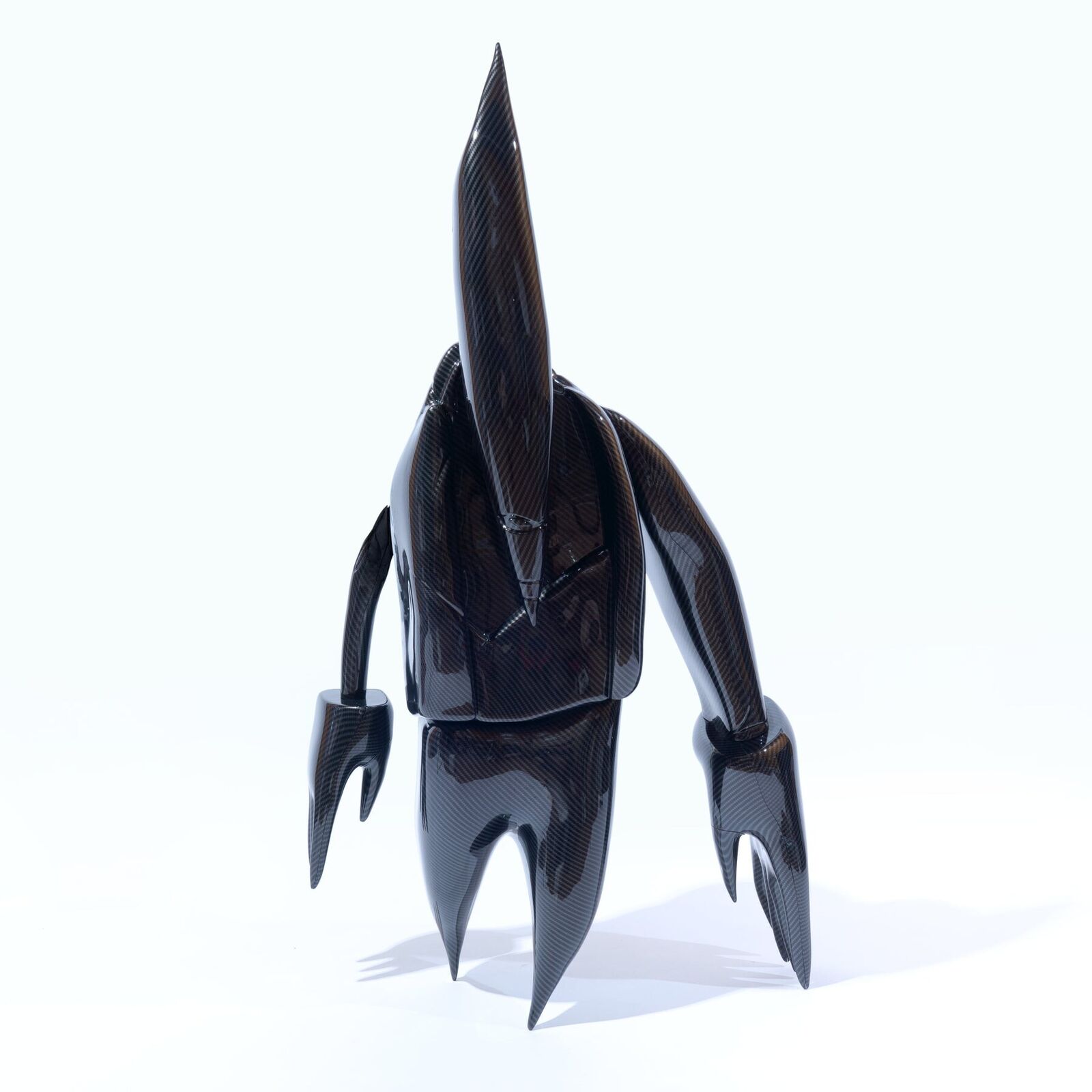 A 3D rendering of a black robot with a long tail.