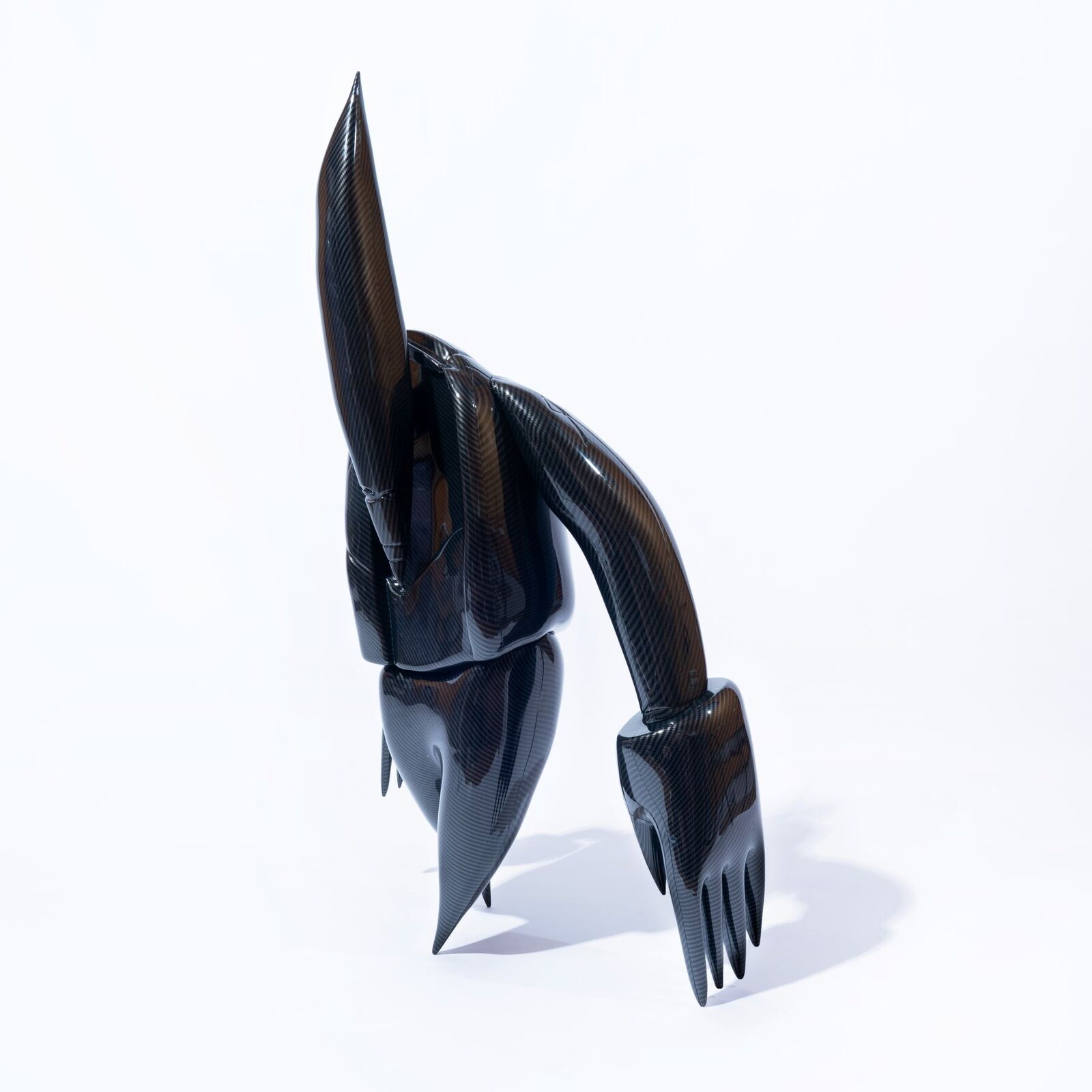 A 3D rendering of a black robot with a long tail.