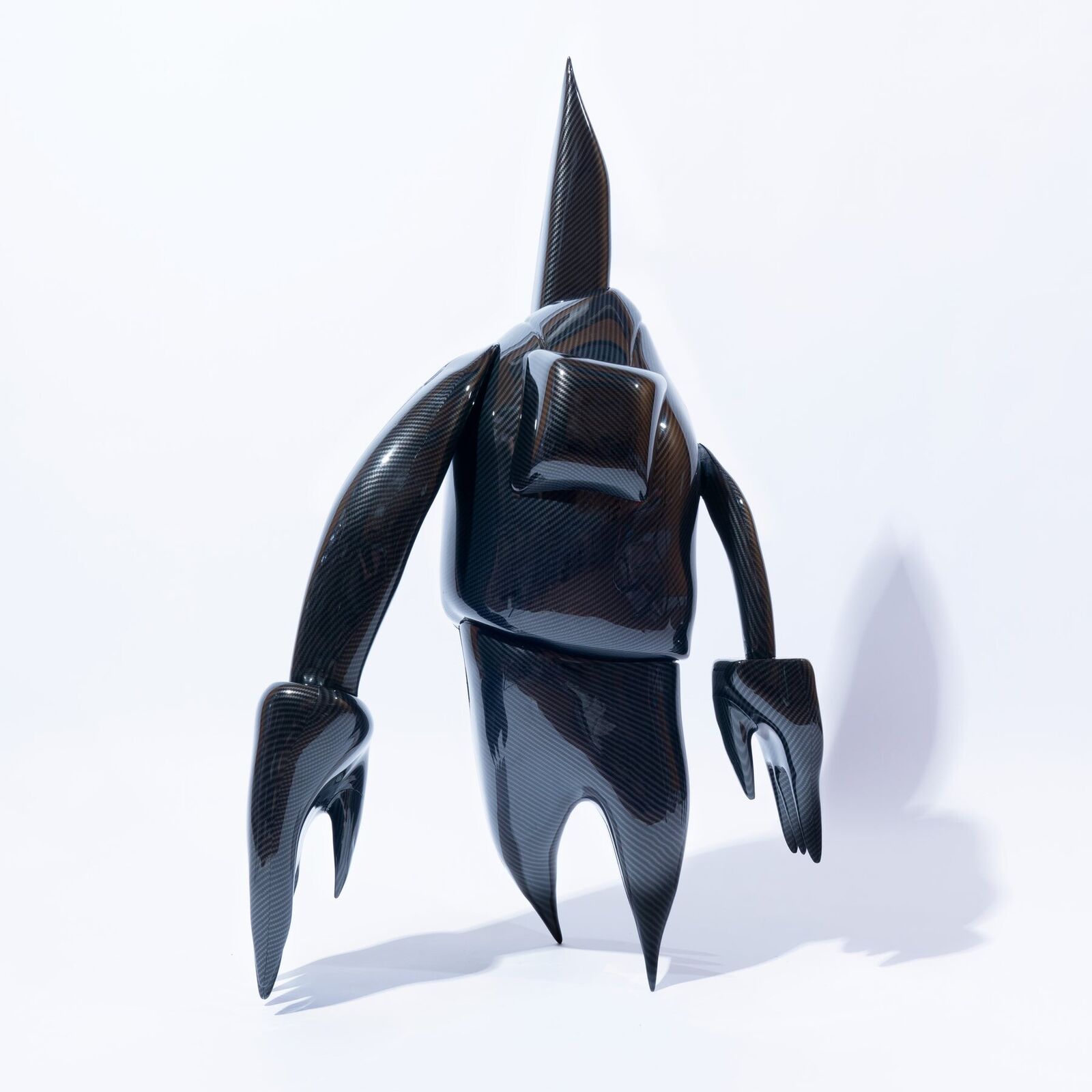 A 3D rendering of a black robot with a long tail.