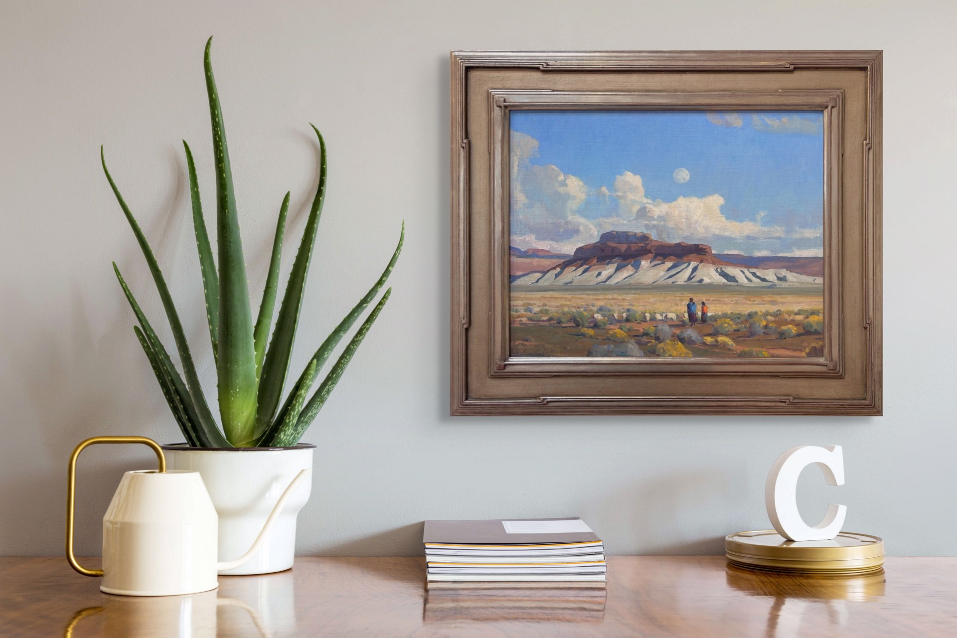 A painting of two people walking in the desert with a full moon in the sky.